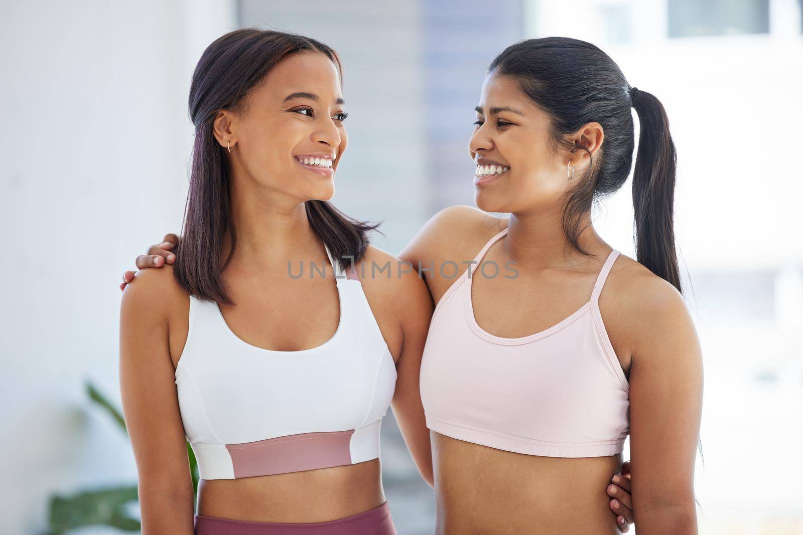 Shot of two sporty young women in a yoga studio.