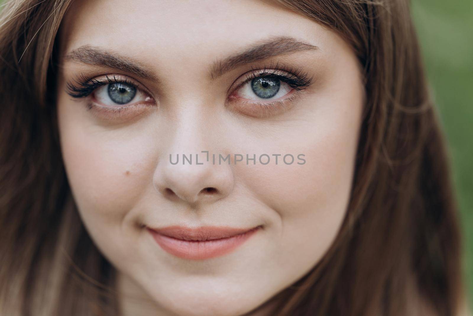 Close-up of Eyes Beautiful Girl. Positive Woman Looking at Camera. Girl opening her Beautiful blue eyes. Natural Beauty Gorgeous woman with long Eyelashes and Attractive Appearance.