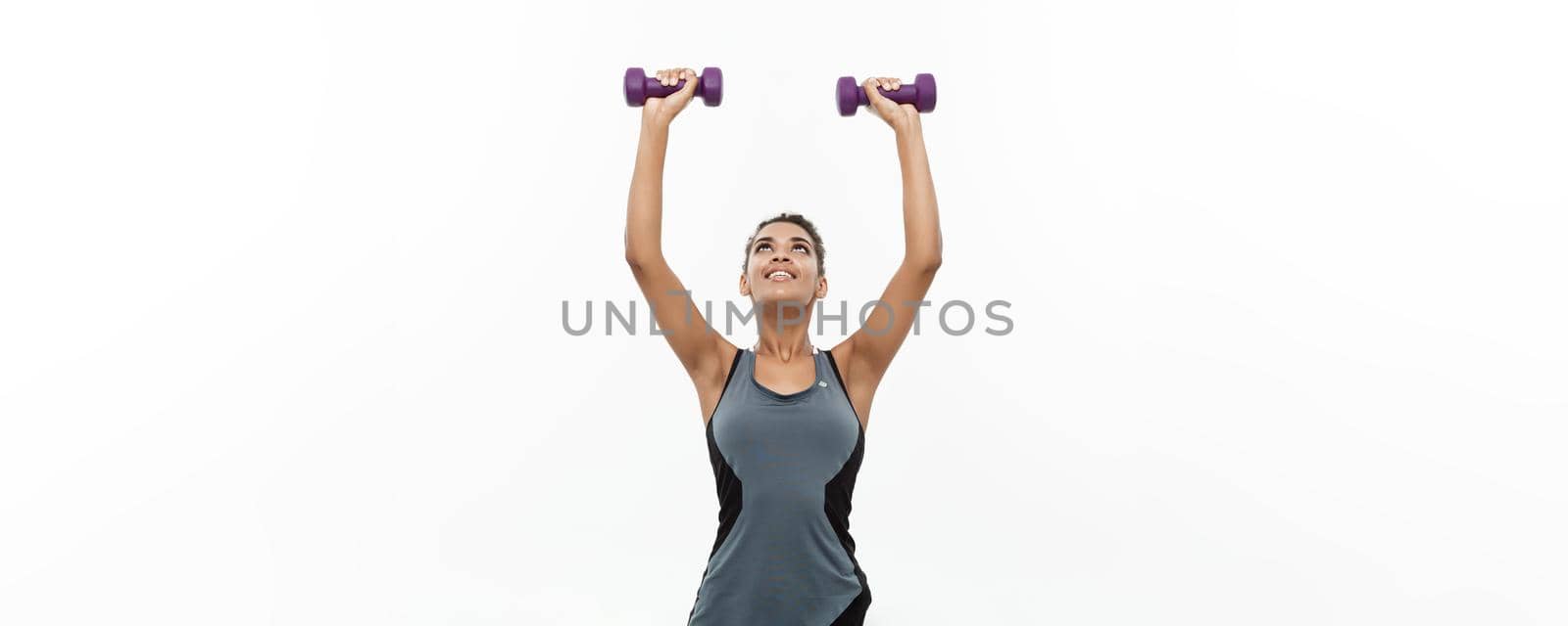 Healthy and Fitness concept - Beautiful American African lady in fitness clothes workout with dumbbell. Isolated on white background