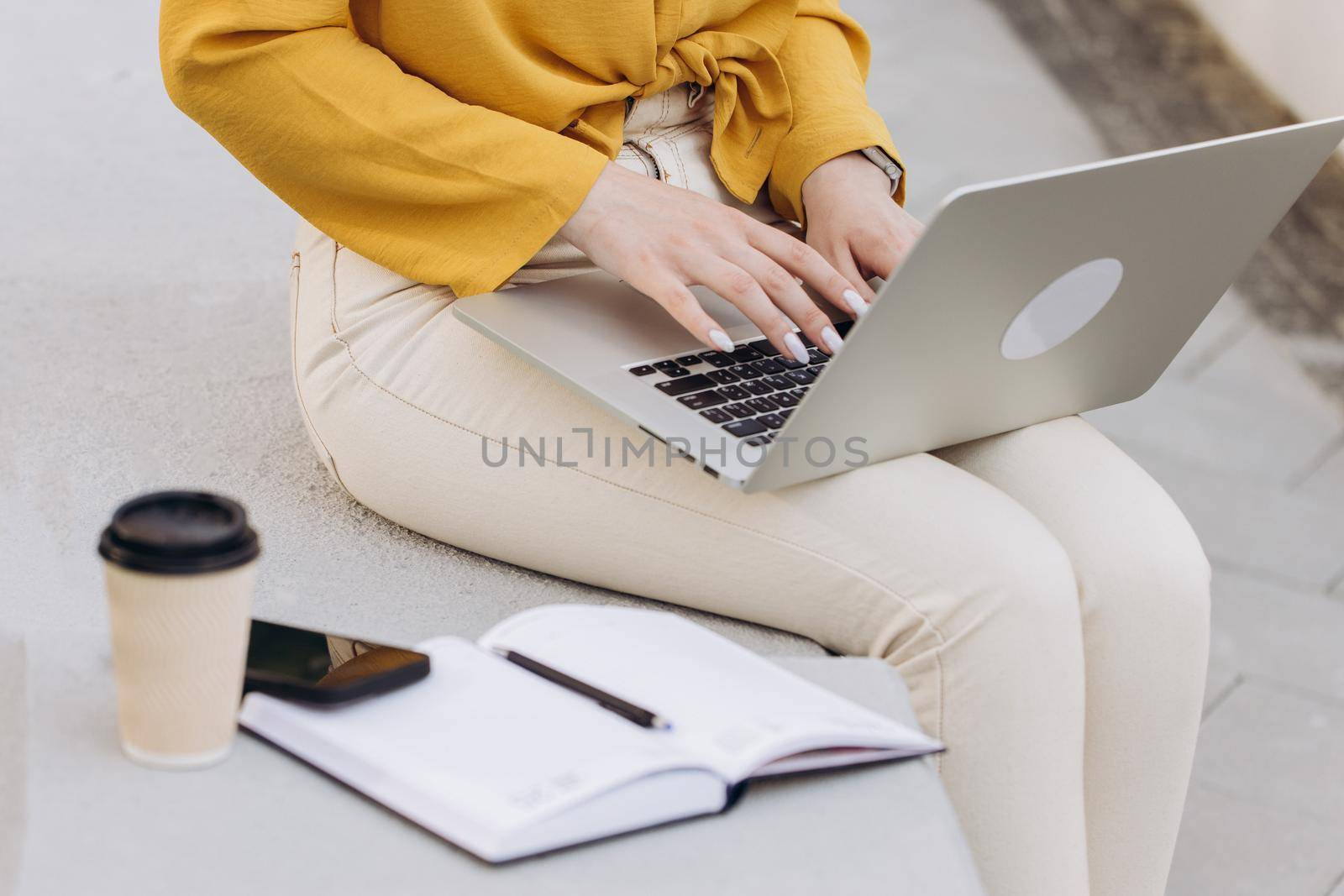 Close up of female hands of business woman professional user worker using typing on laptop notebook keyboard sit at office outside working online with pc software apps technology concept by uflypro