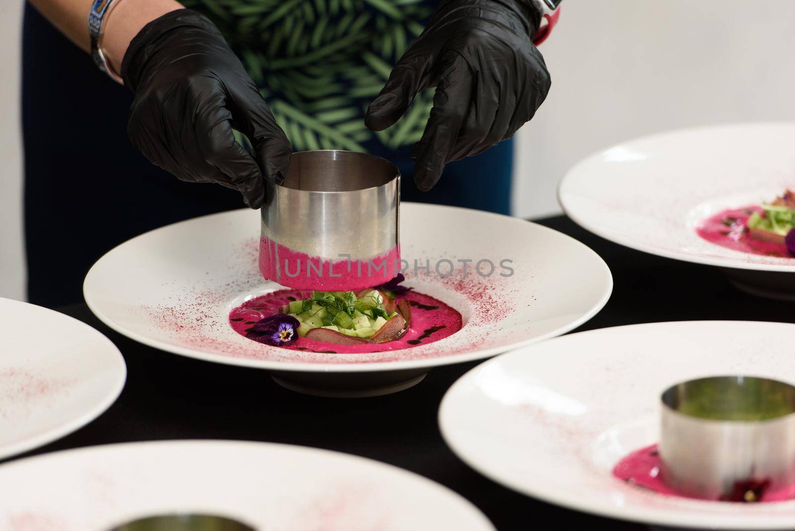 Chief serving soup with pickled beets and tongue. Preparation of borscht. . Polish cuisine. Healthy food. Beet juice. Natural treatment.