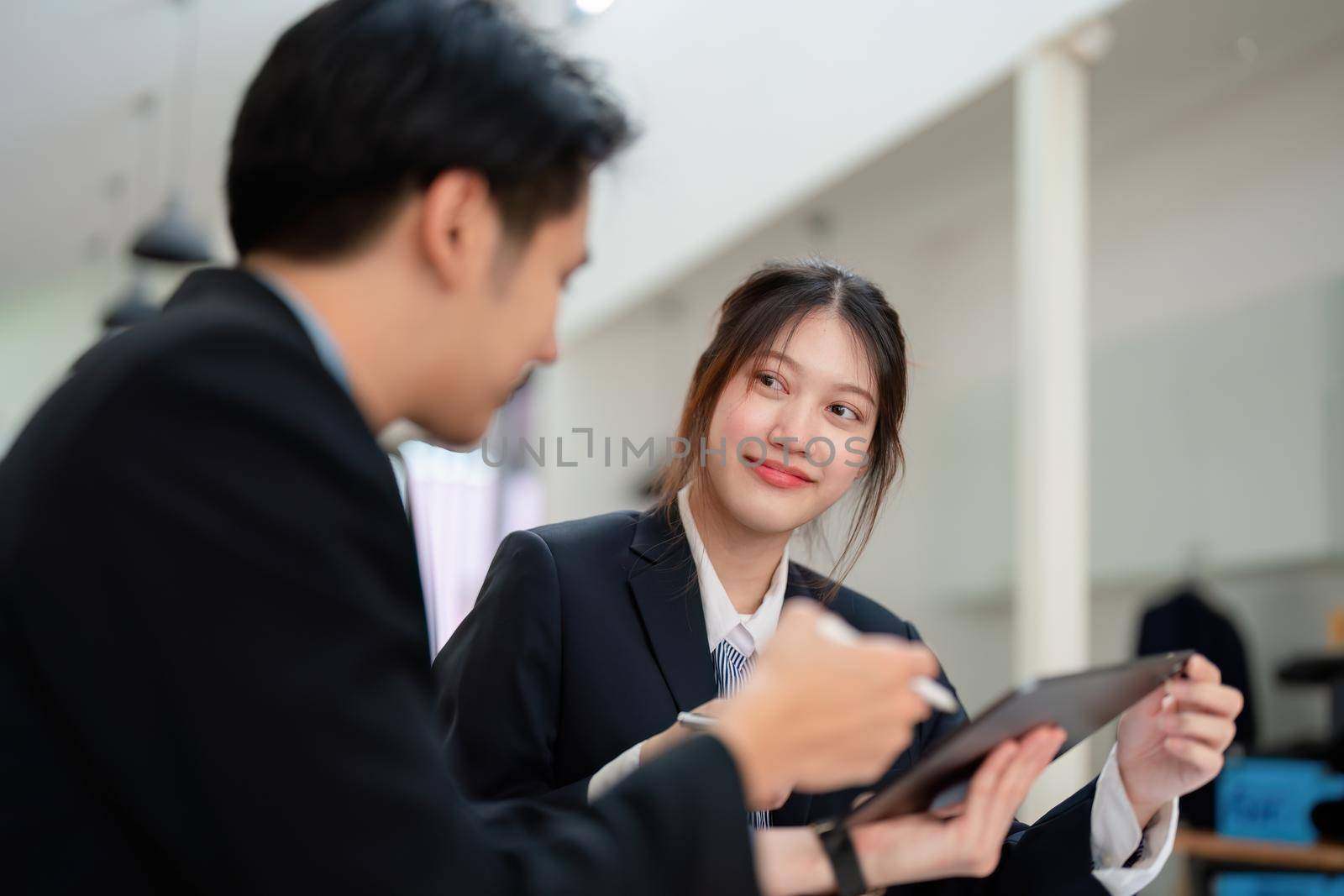 Asian portrait of people working together on a new project to analyze budgets and manage investment risks in today's profit boosting for marketing in the office room.