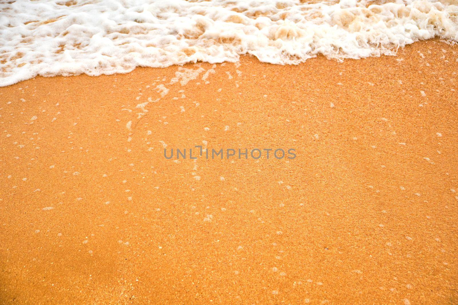 Top view over beach sea. Beautiful sea waves. Beach sand and amazing sea. Summer seascape. Water texture background.