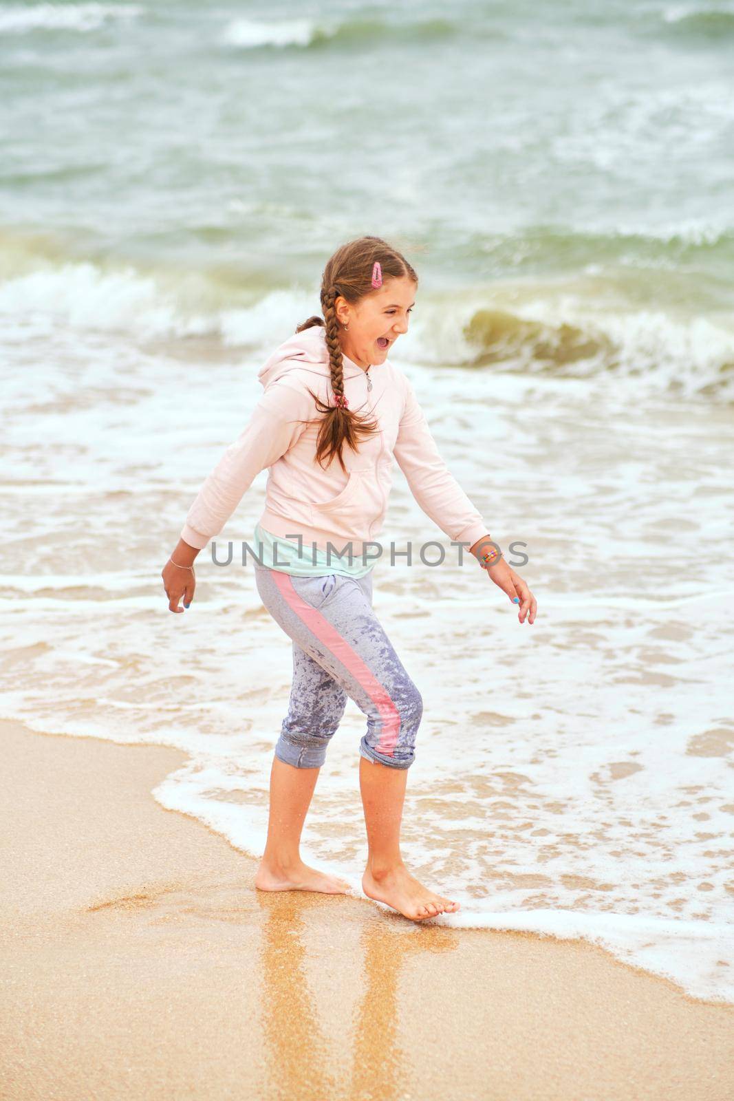 Happy child playing in the sea. by InnaVlasova