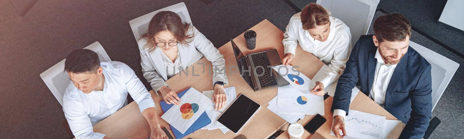 top view photo of business people in modern it office on meeting. High quality photo