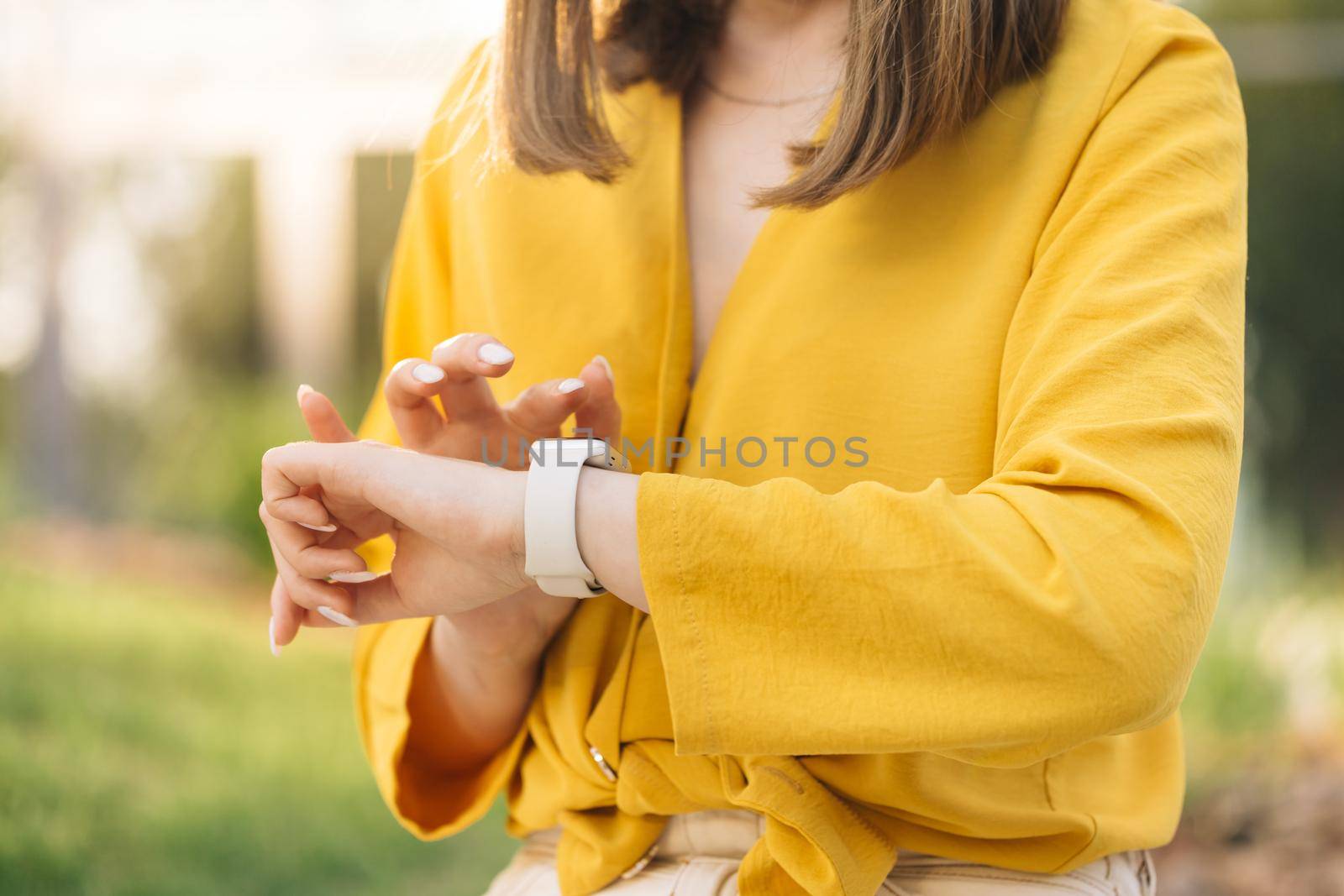 Close up of woman hand with smartwatch. Checking incoming notification on smart watch. Scrolling display on smartwatch. Caucasian girl using smartwatch by uflypro