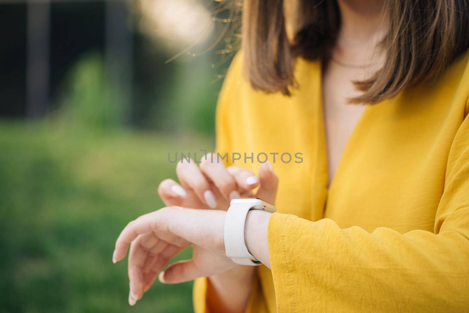 Checking incoming notification on smart watch. Scrolling display on smartwatch. Caucasian girl using smartwatch. Close up of woman hand with smartwatch.
