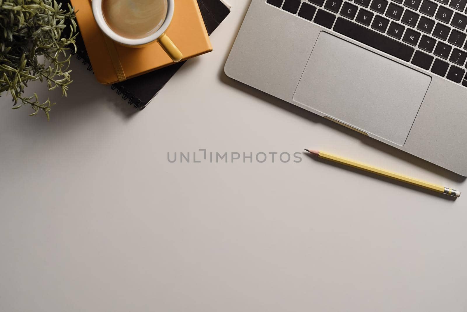 Top view minimal workspace with laptop computer, coffee cup and notebook. by prathanchorruangsak