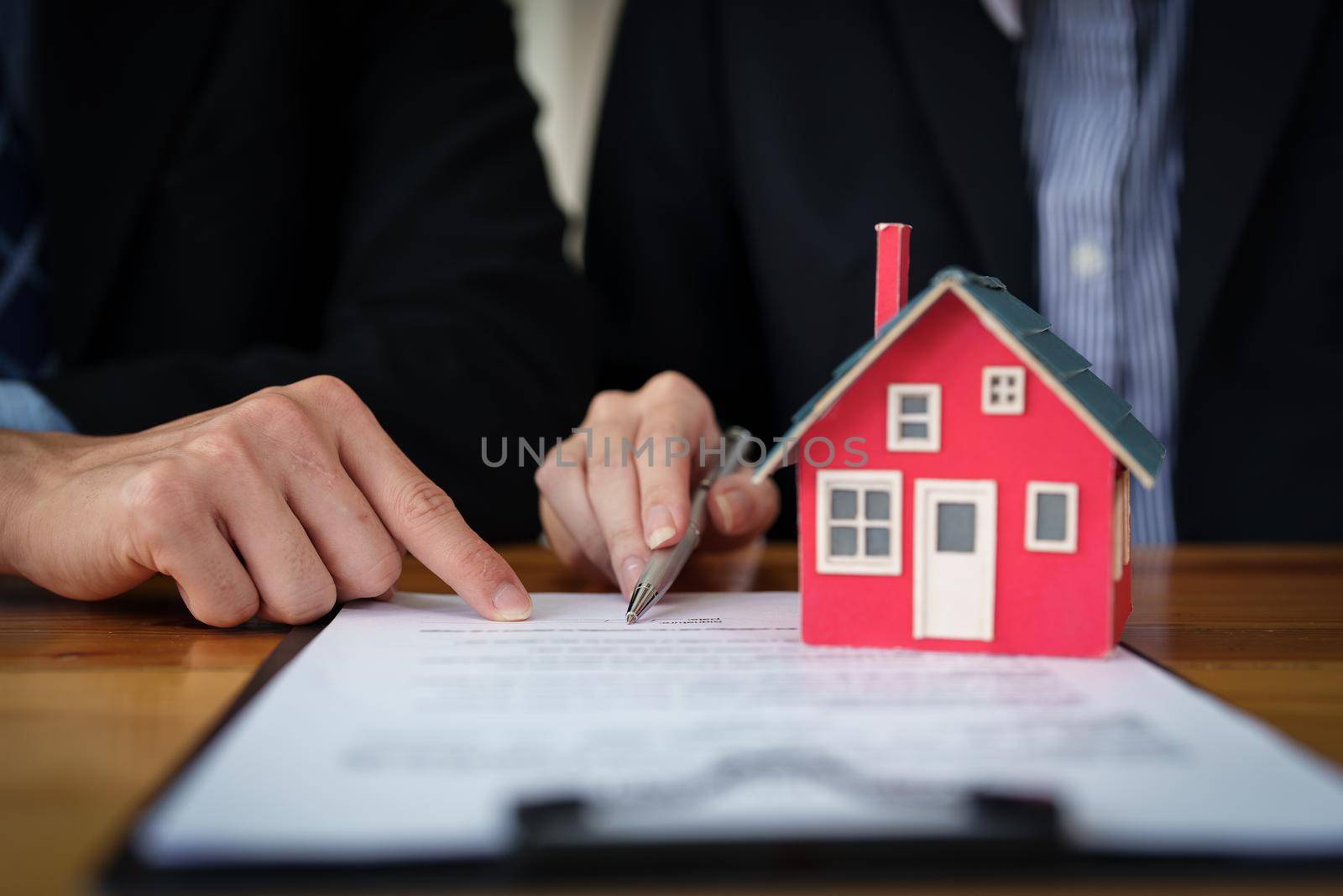 Guarantees, mortgages, signing, interest on loans, real estate agents are making agreements with customers to buy houses and land and sign contract documents by Manastrong