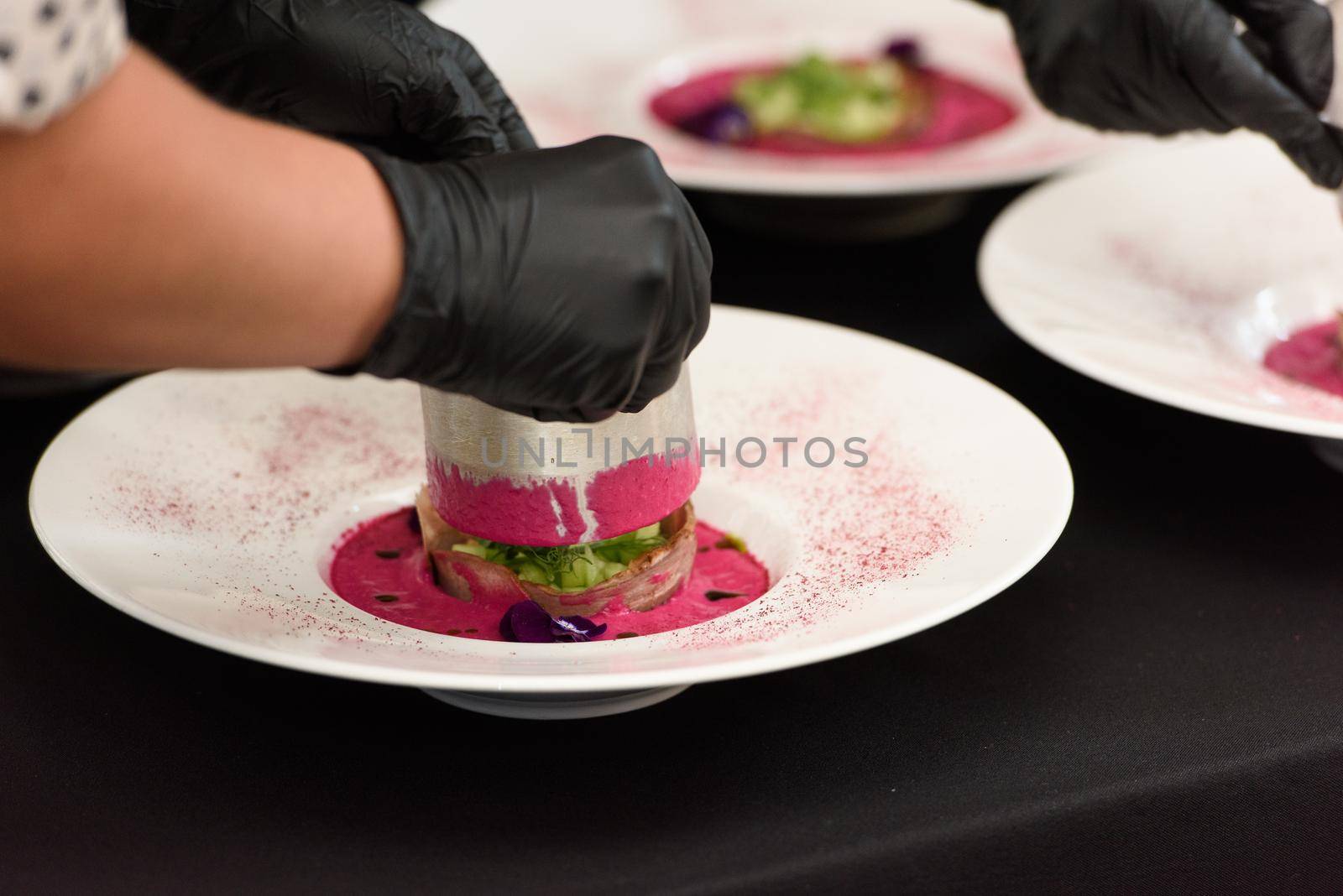 Chief serving soup with pickled beets and tongue. Preparation of borscht. . Polish cuisine. Healthy food. Beet juice. Natural treatment.