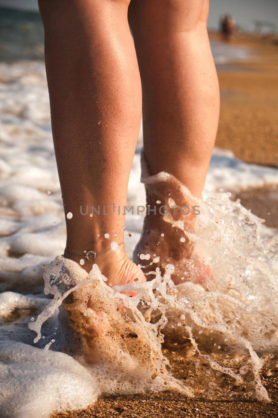 The woman's legs close up. Barefoot on the sand and the sea shore. A woman's feet a woman walks along the coast of the sea. lifestyle