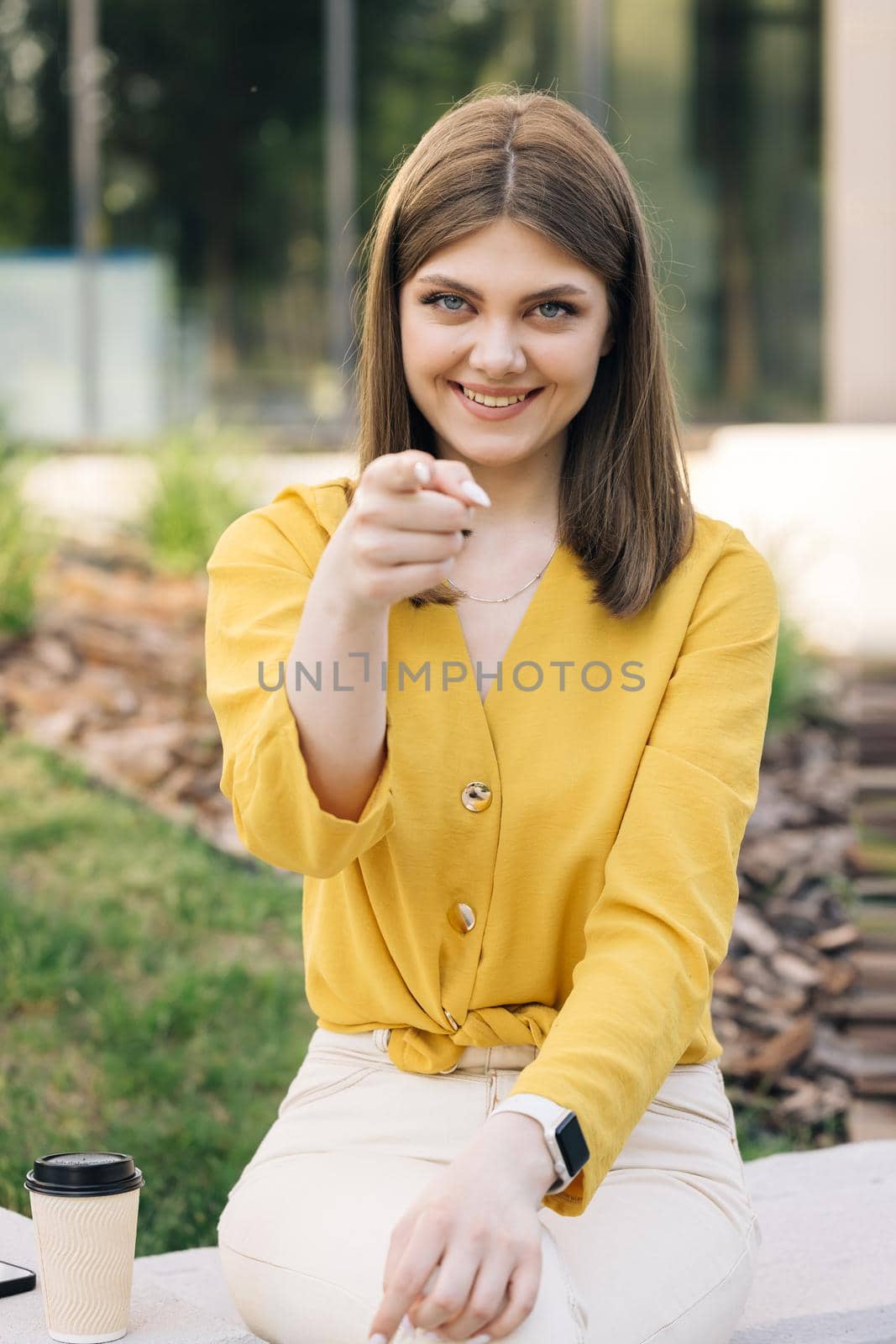 Beautiful european ukraininan girl pointing index finger at camera inviting with hand gesture. Young ethnic happy woman calling to showing something and speaking body language. Hey you, come here.