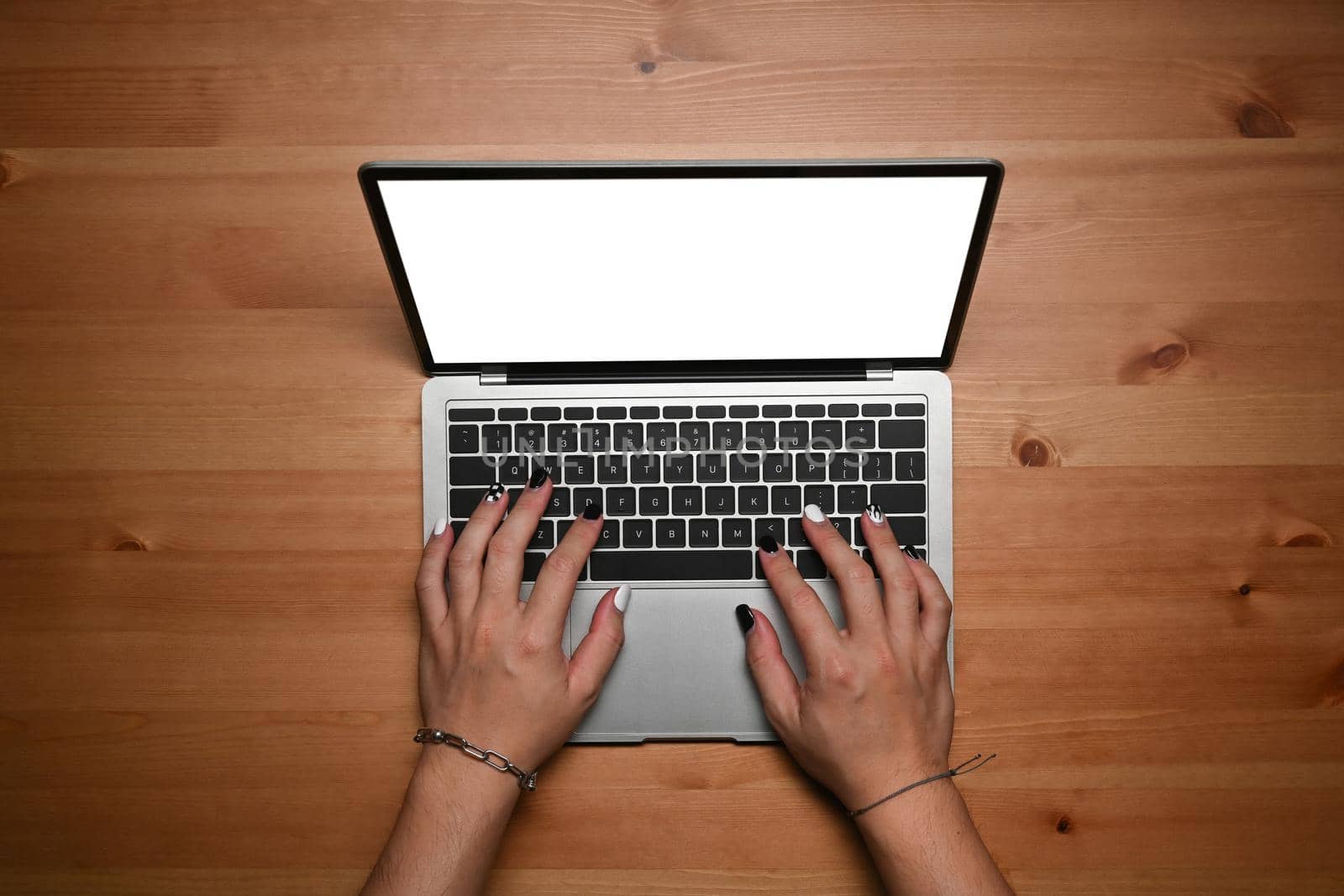 Overhead view female freelancer hands typing on laptop computer. by prathanchorruangsak