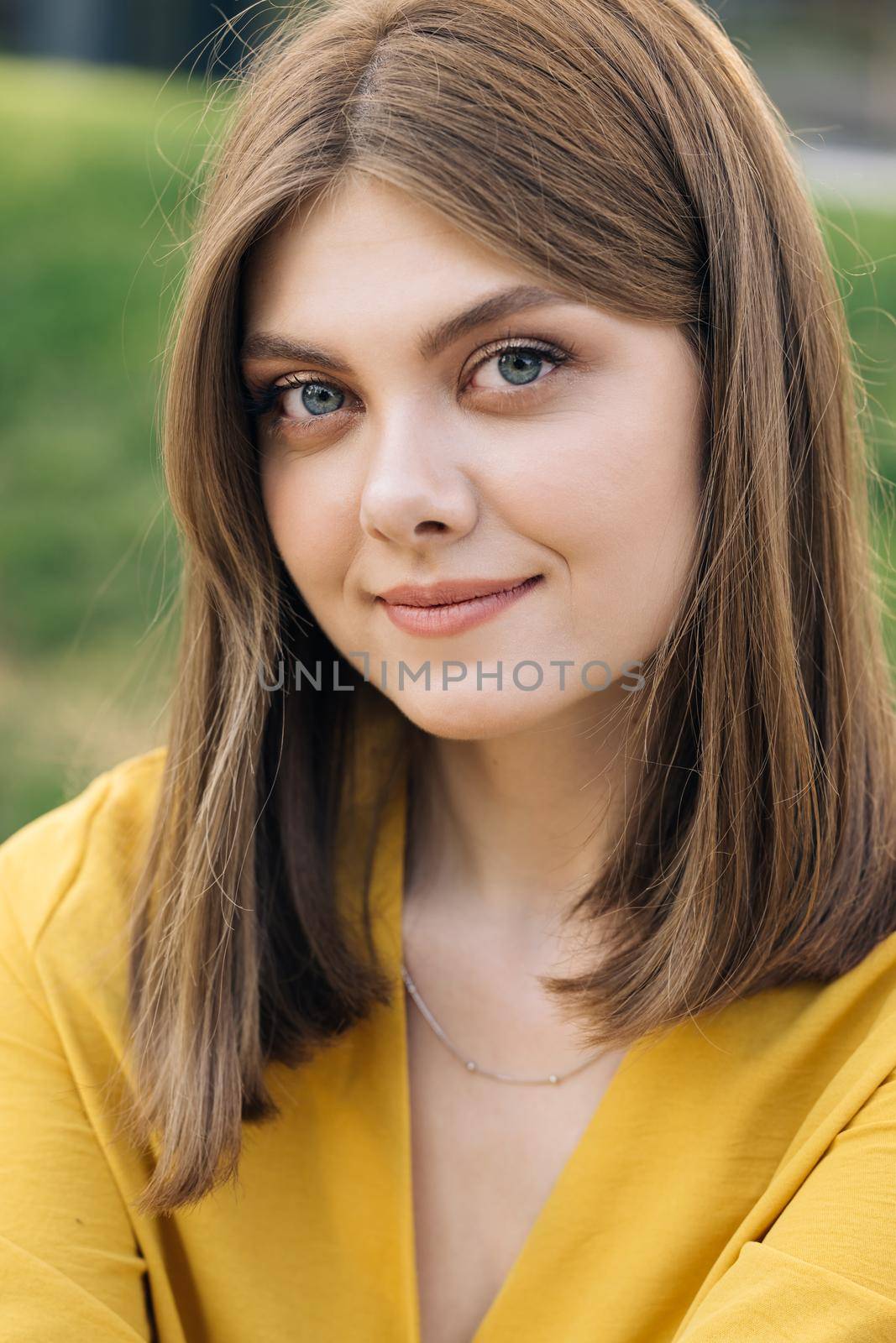 Amazing portrait of lovely young woman in city streets. Attractive positive caucasian business girl smiling for camera. Summer beautiful lady portrait happy outdoor by uflypro