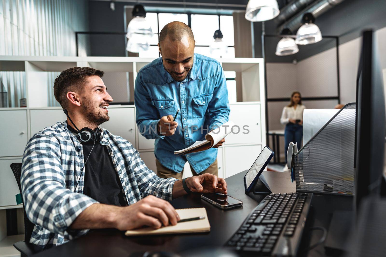 Two young men working together on a new business project in office, close up