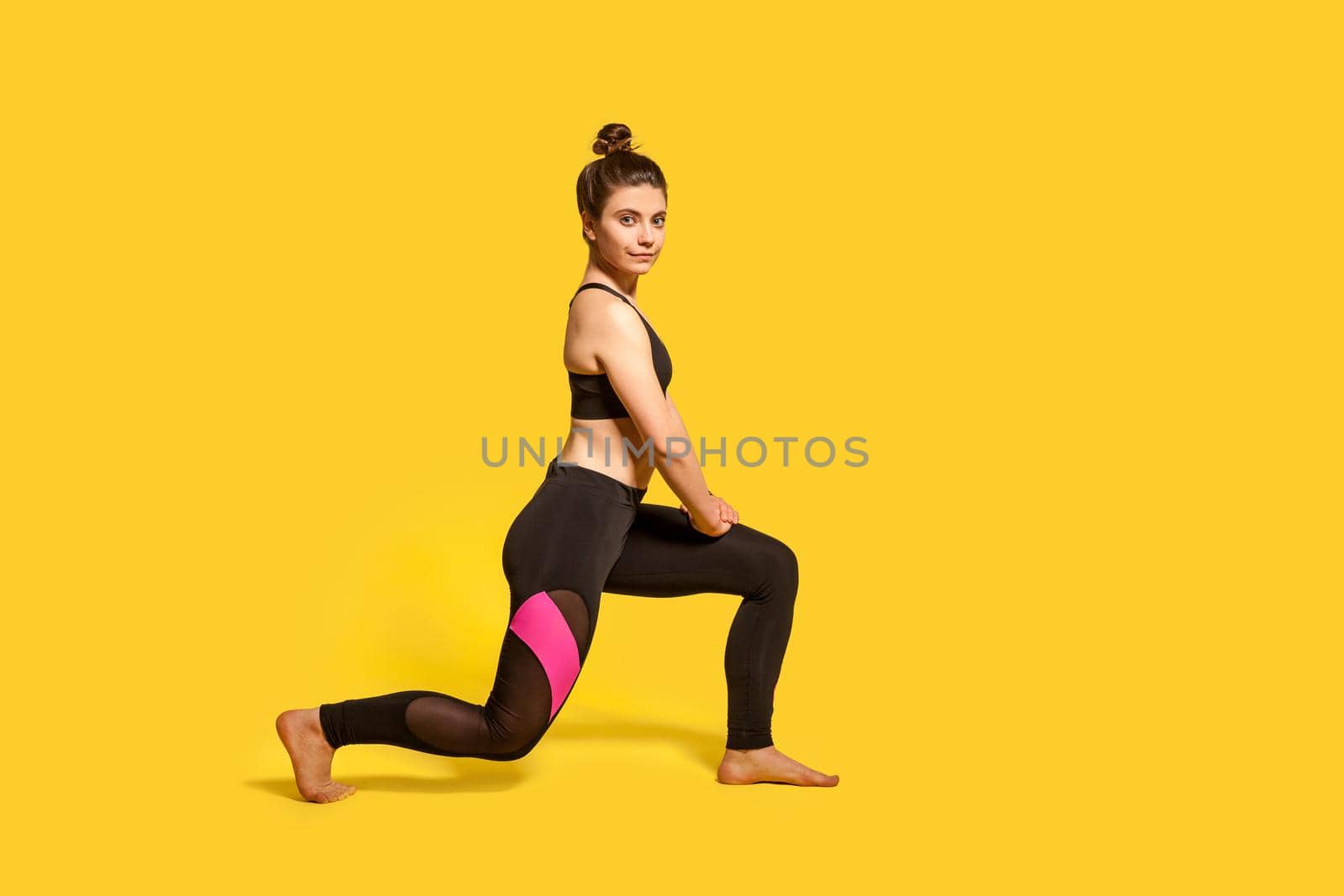 Indoor sport of young woman on yellow background. by Khosro1