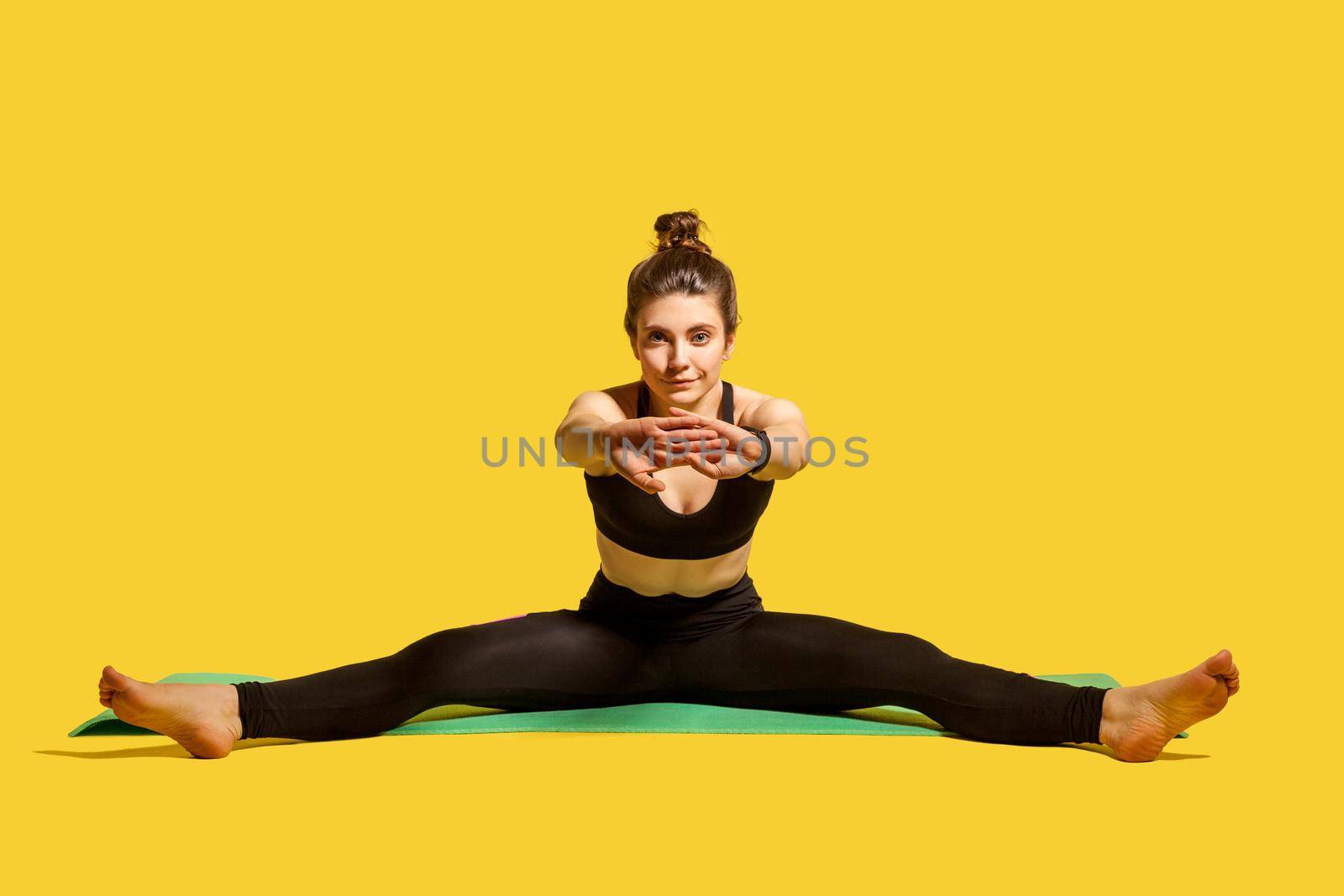 Indoor sport of young woman on yellow background. by Khosro1