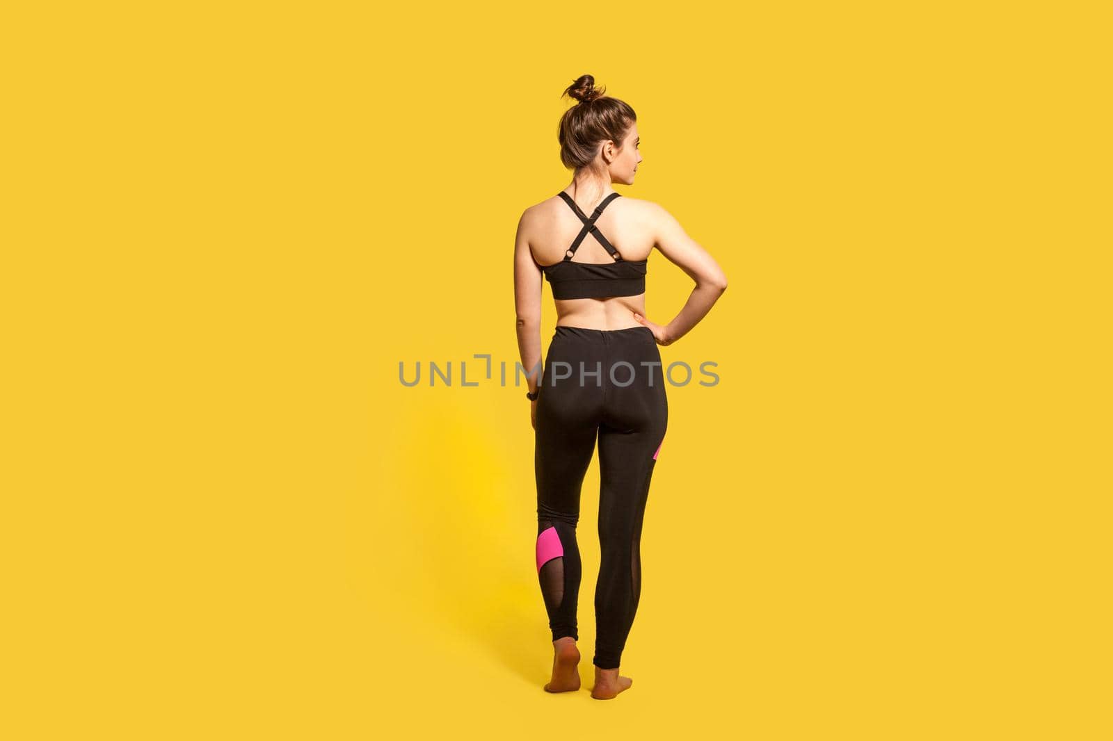 Indoor sport of young woman on yellow background. by Khosro1