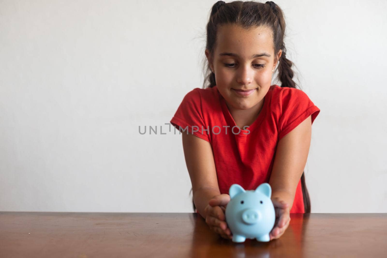 Little child girl with piggy bank at home by Andelov13