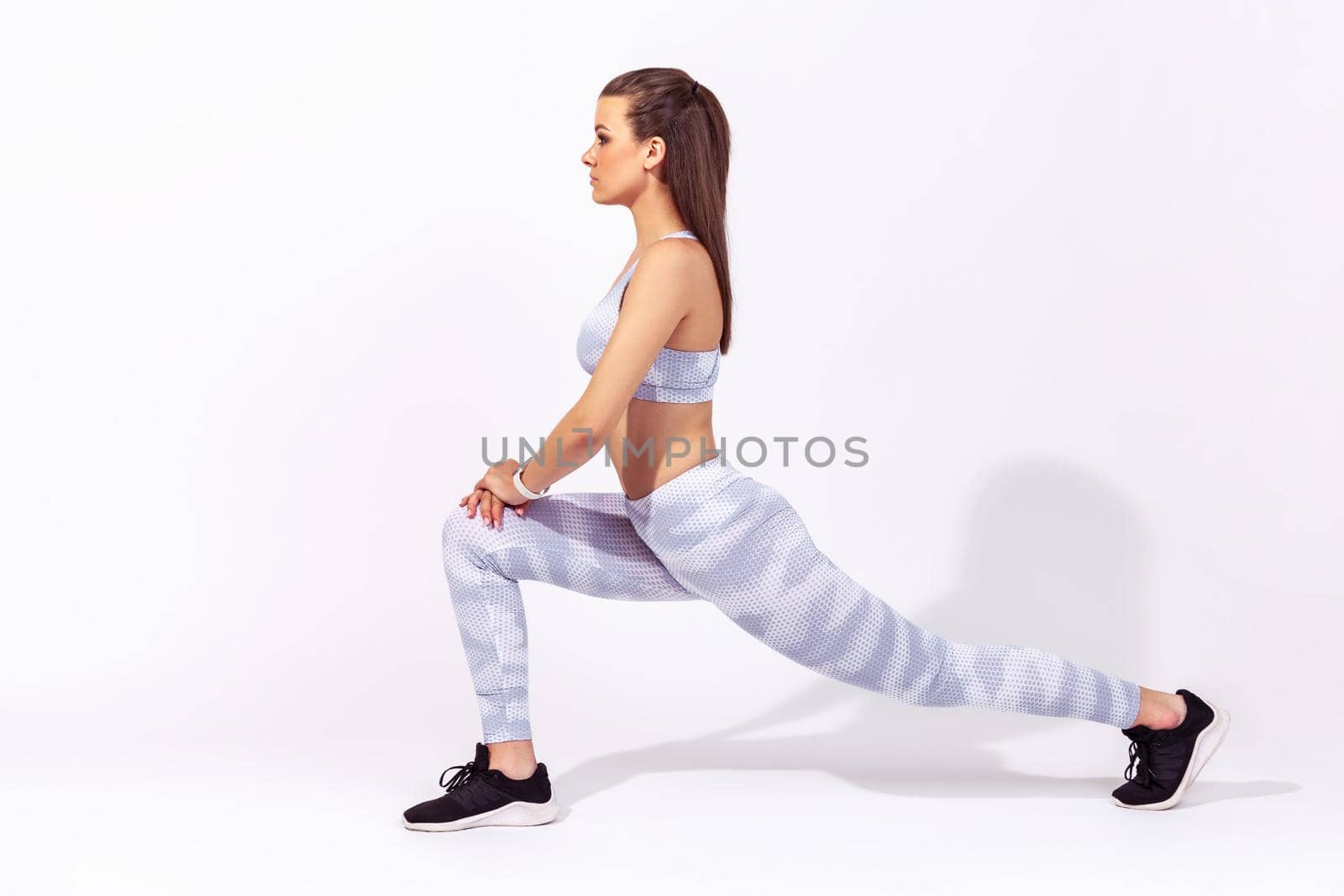 Indoor sport of young woman on white background. by Khosro1