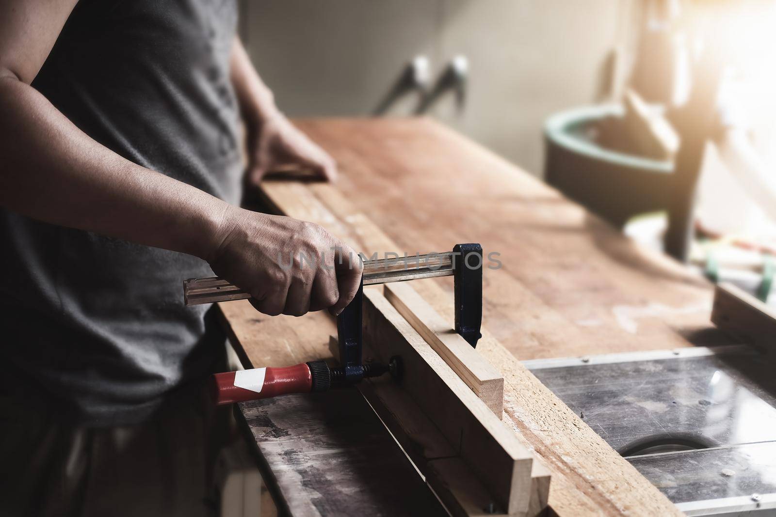 Woodworking operators are decorating pieces of wood to assemble and build wooden tables for customers