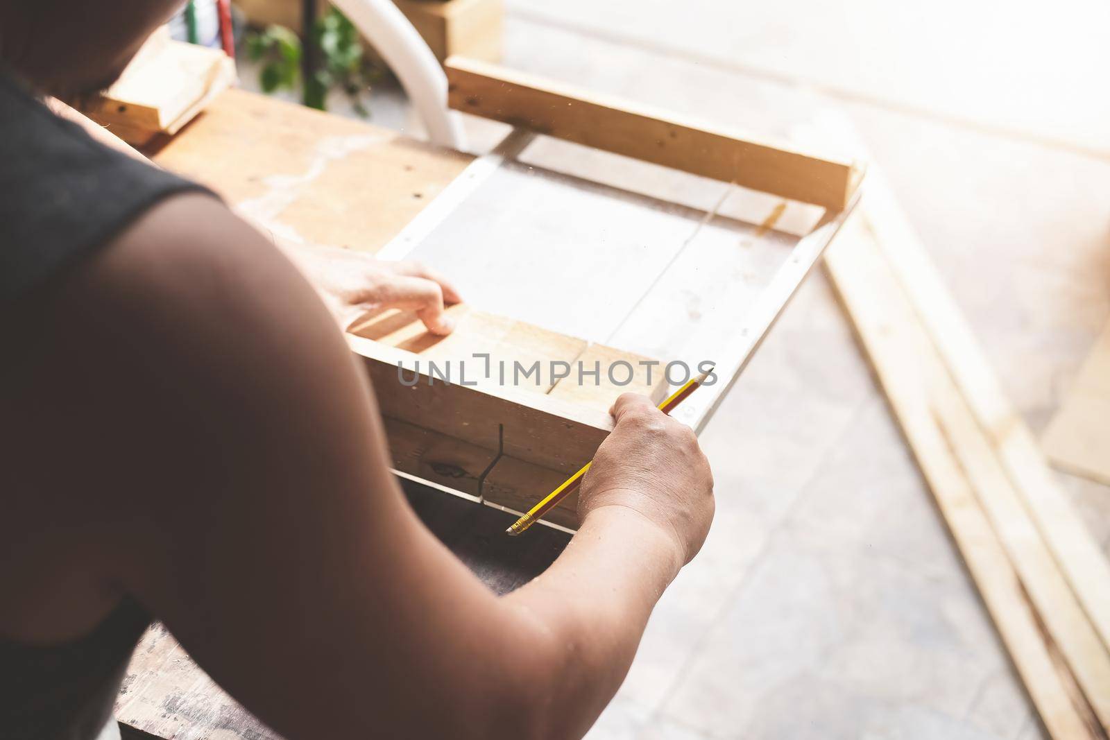 Woodworking practitioners use saw blades to cut wood pieces to assemble and build wooden tables for their clients.