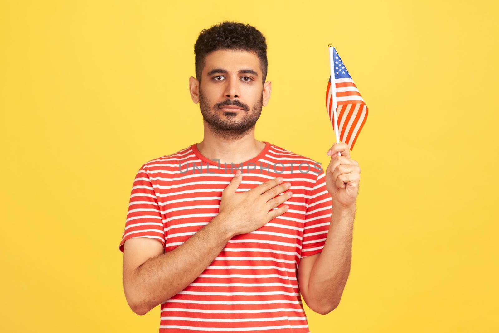 Emotional young man in red t-shirt on yellow background. by Khosro1