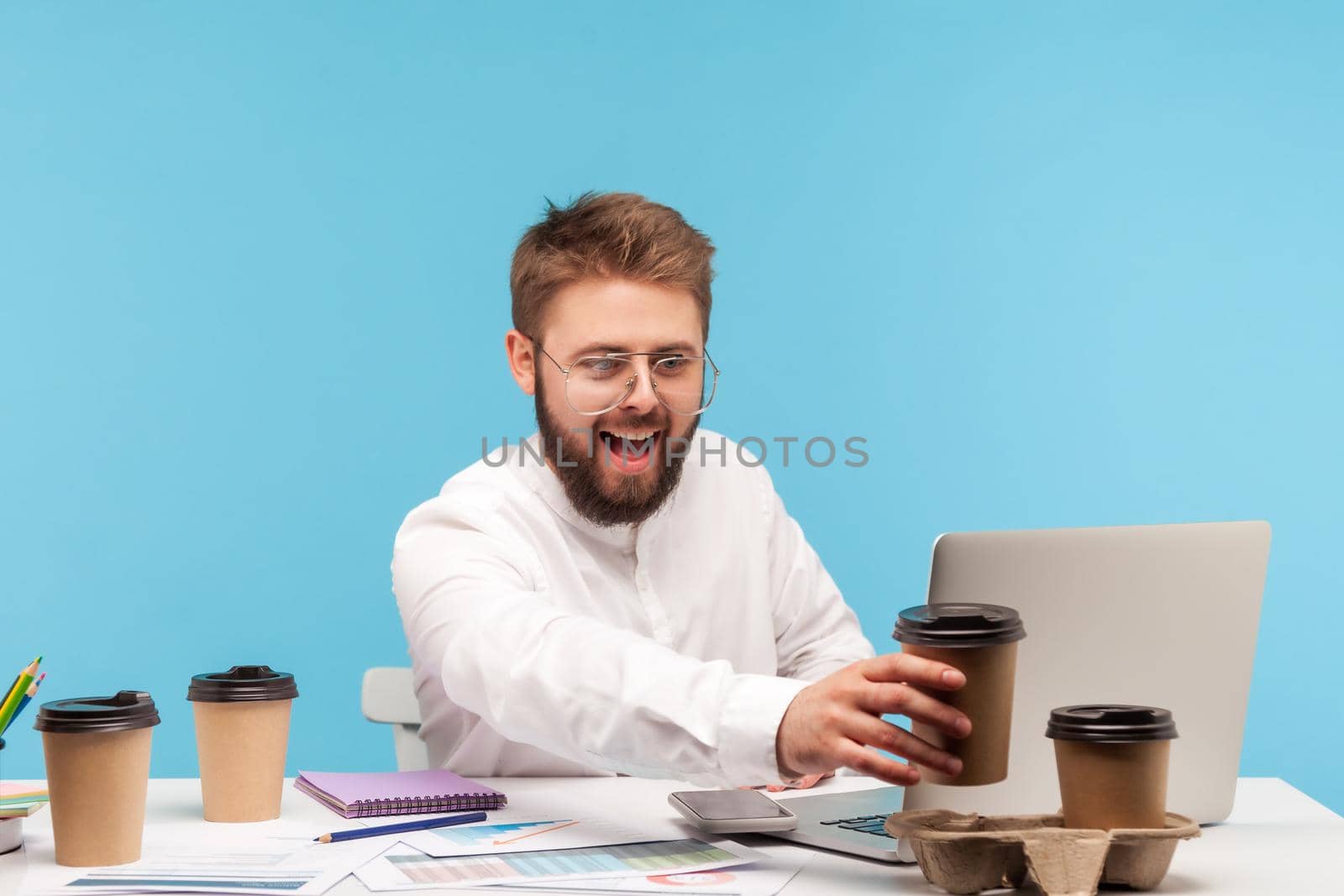 Emotional businessman working on laptop on blue background. by Khosro1