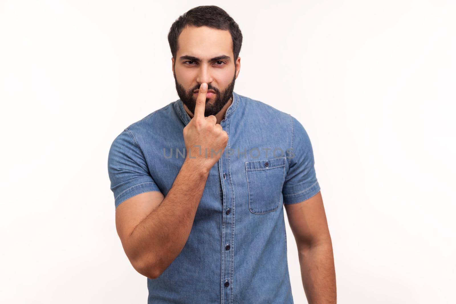 You are liar. Angry dissatisfied man with beard pointing finger at nose, showing lie gesture, blaming and suspicion you, body language. Indoor studio shot isolated on white background