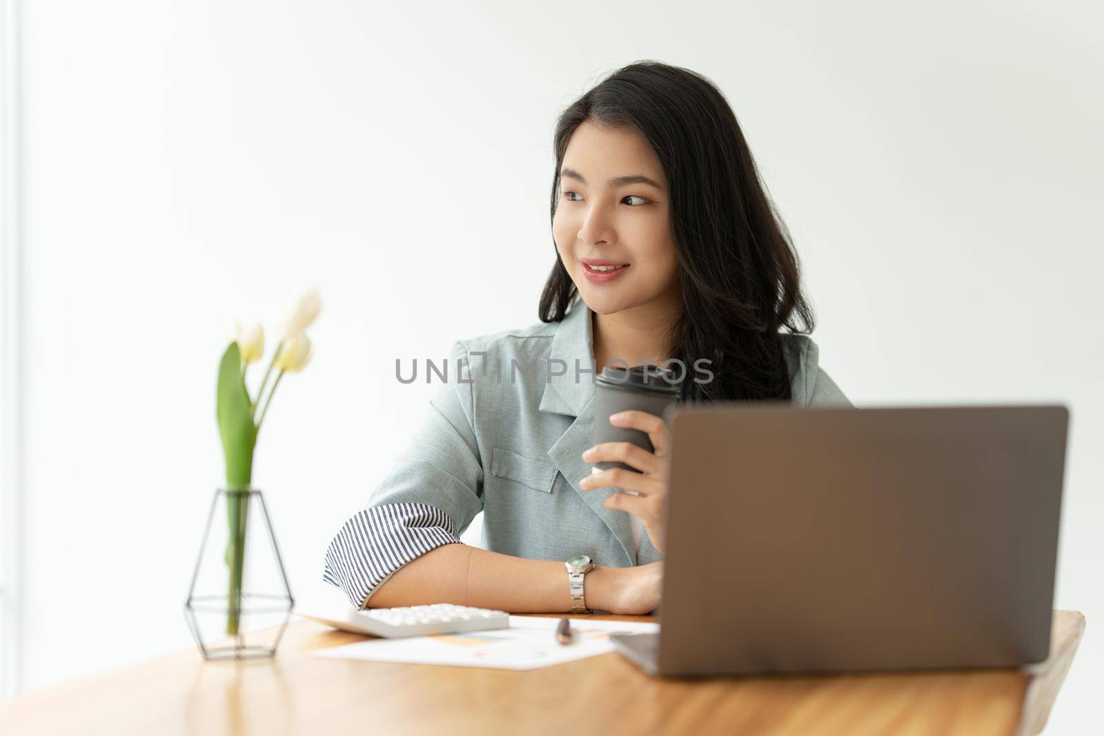 Portrait of Asian Business woman with coffee at morning at home. Account and Finance concept