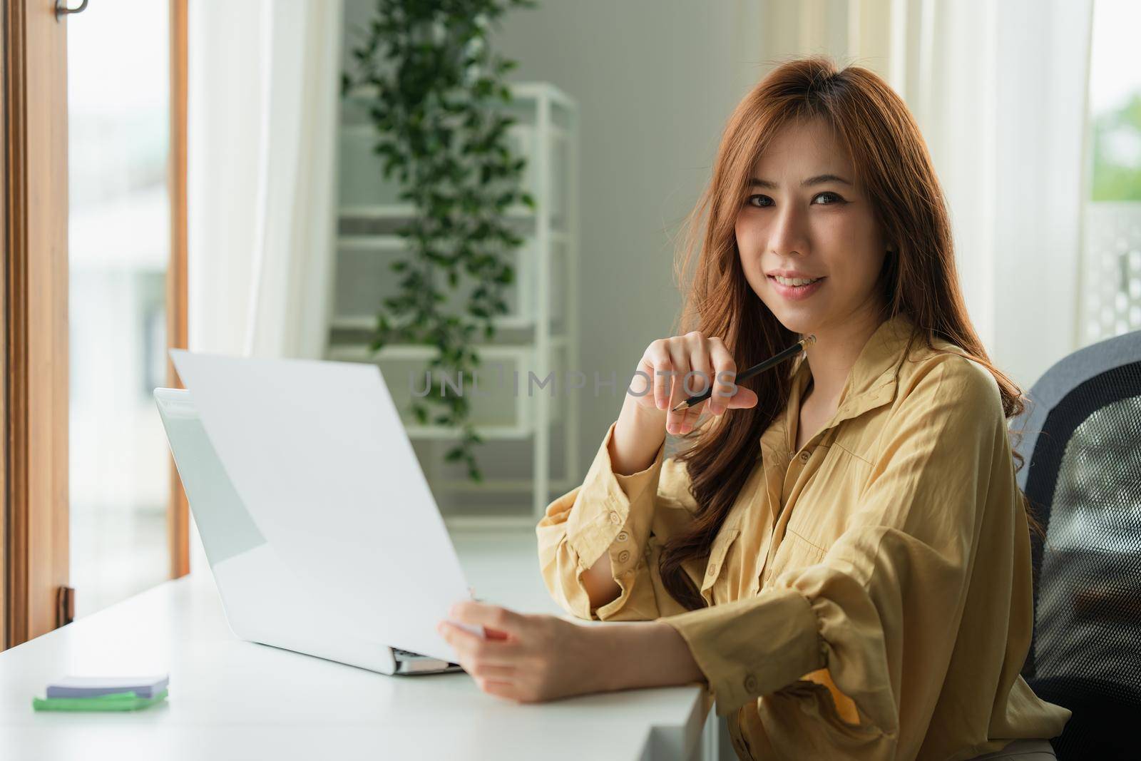 Image of Young woman working online on laptop computer. studying or working from home online concept