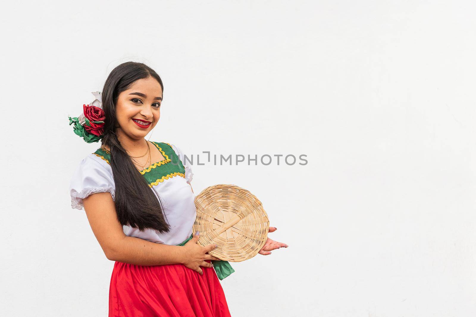 Portrait of young latin girl on white background smiling to camera