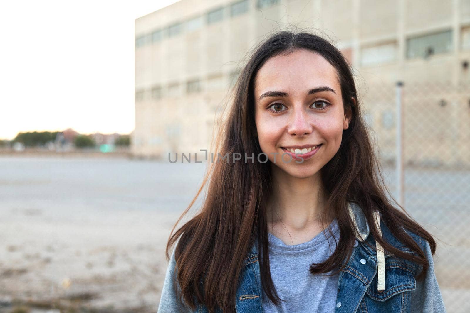 Portrait of happy caucasian girl with long hair looking at camera. Copy space. Headshot.