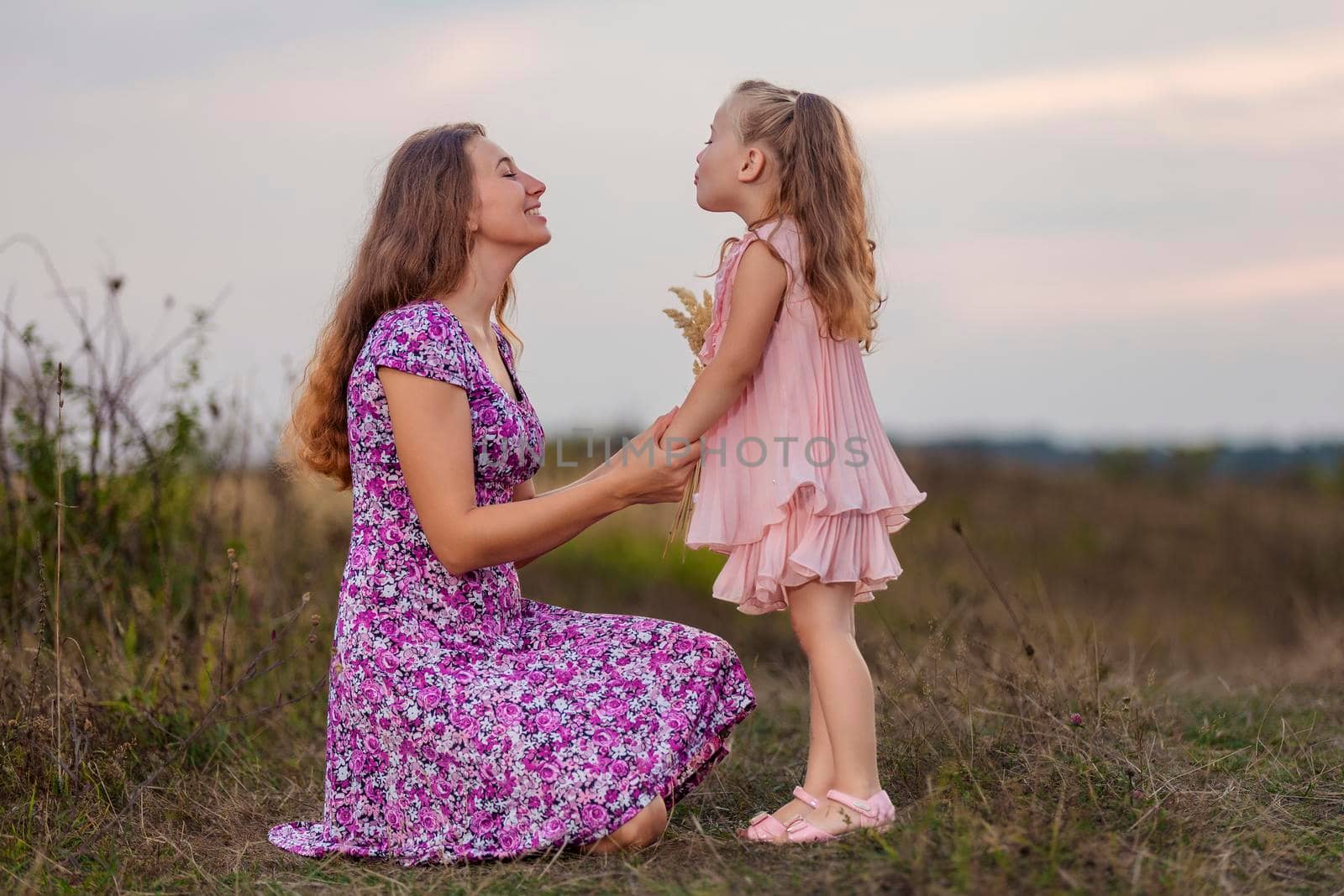 mother with her little daughter walking in nature