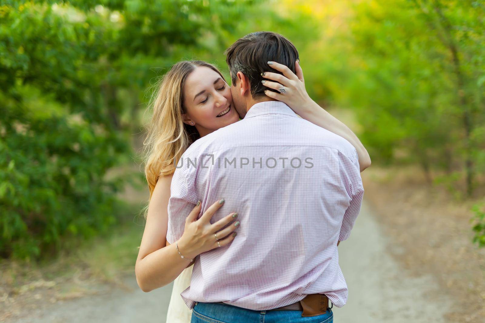 Adult couple in love outdoor. Stunning sensual outdoor portrait of young hugging couple posing in summer in field