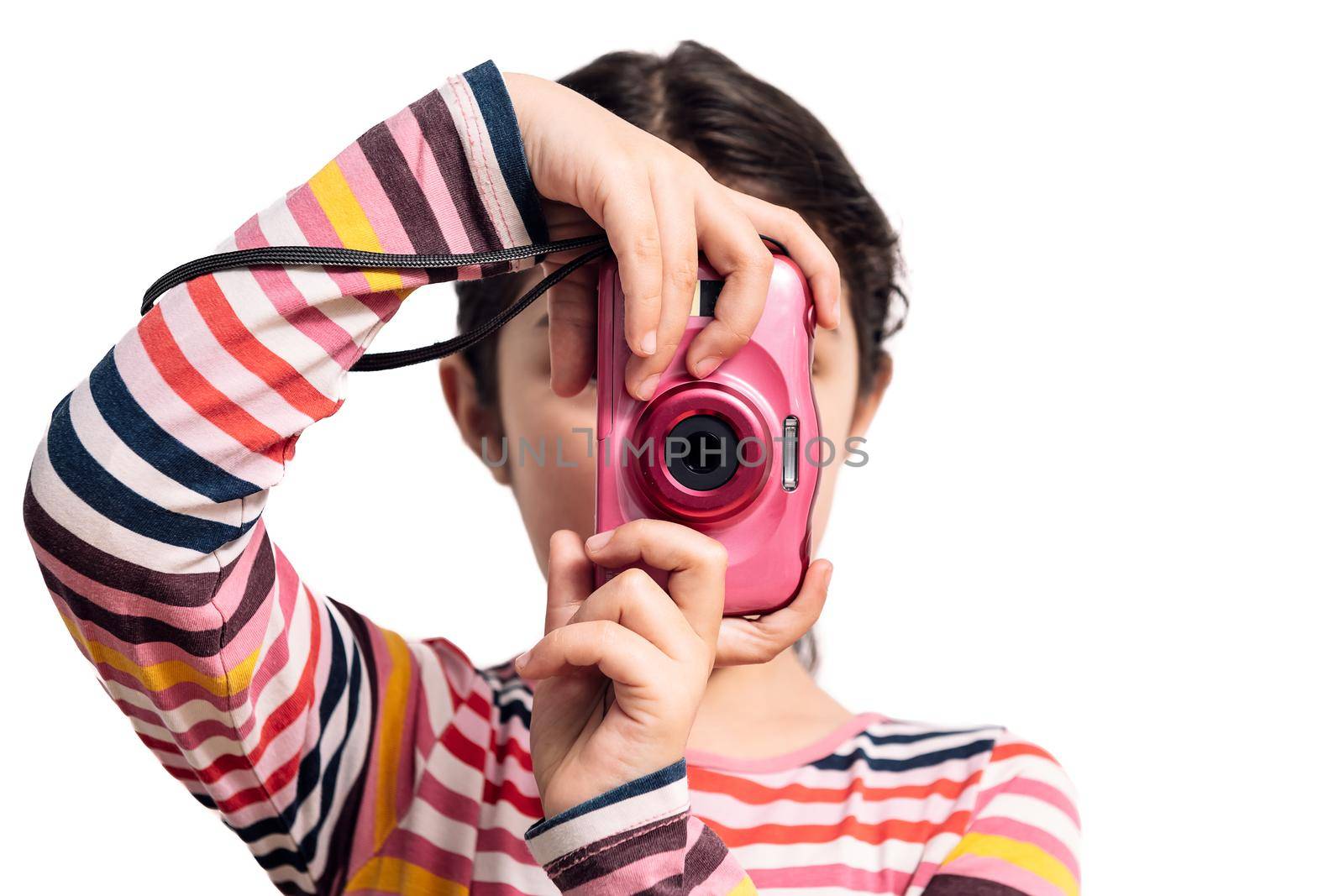 horizontal photo of a child isolated on a white background taking pictures with her pink camera, concept of kids and their hobbies
