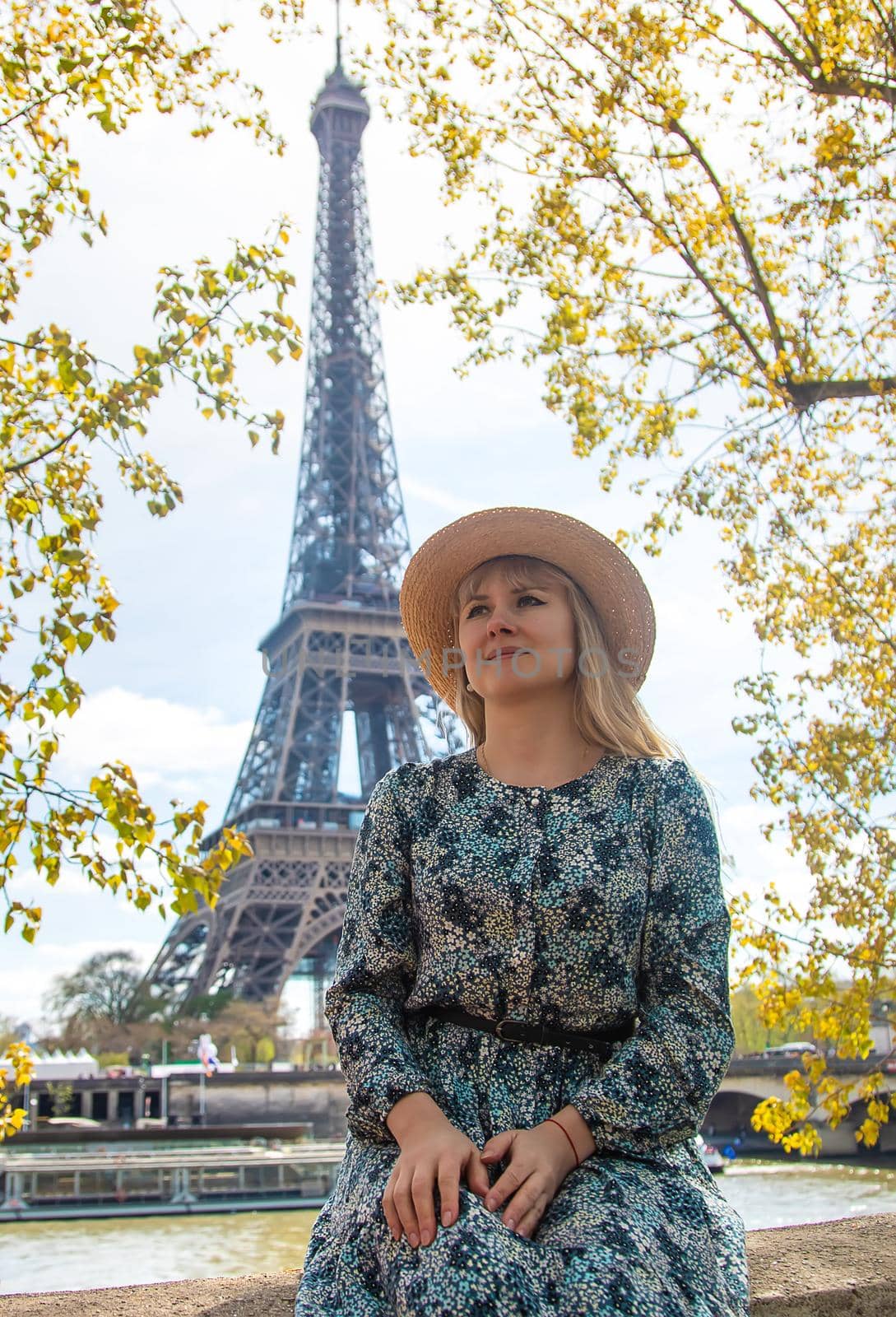 Woman in a hat near the eiffel tower. Selective focus. People.