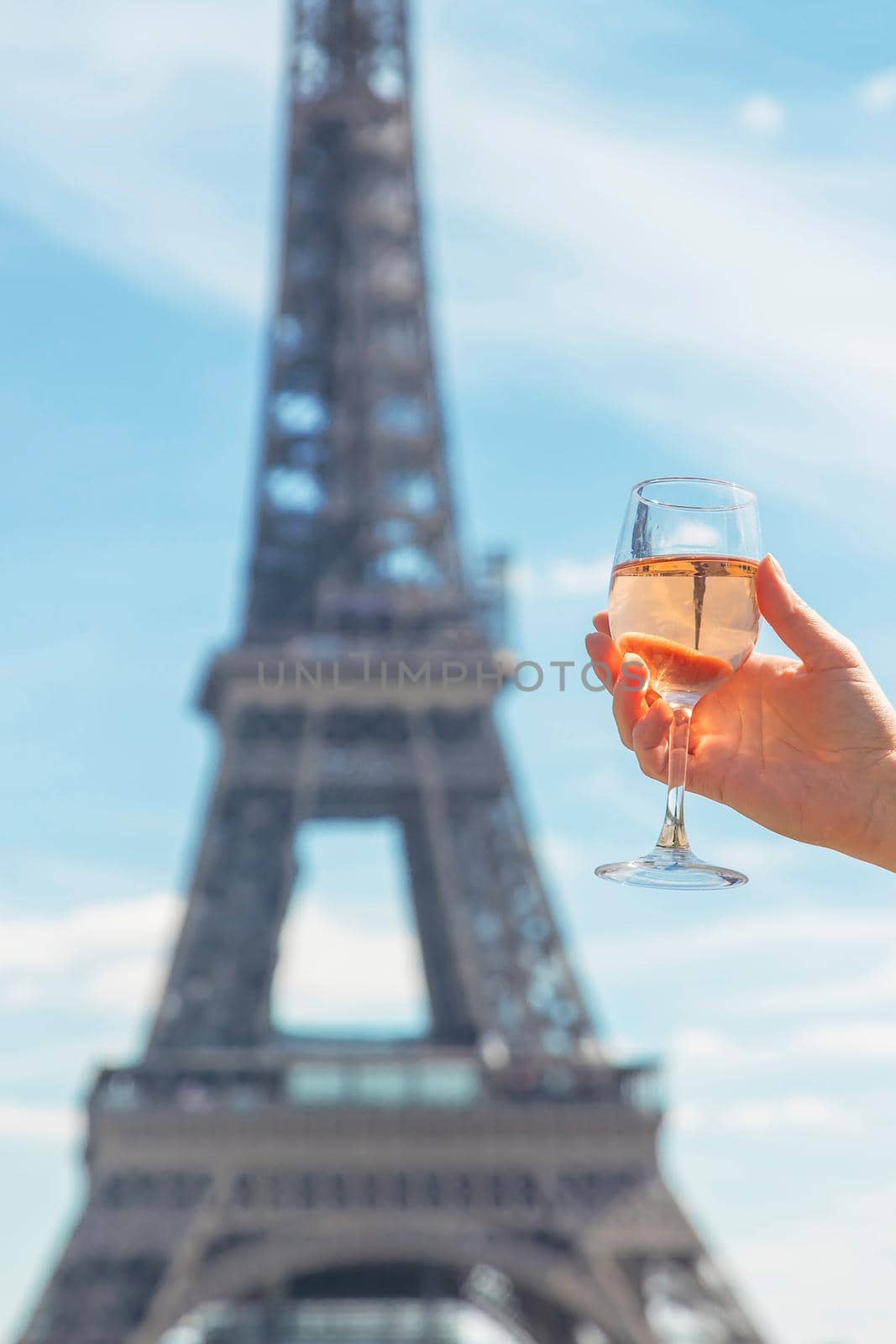 Woman with wine near the eiffel tower. Selective focus. People.