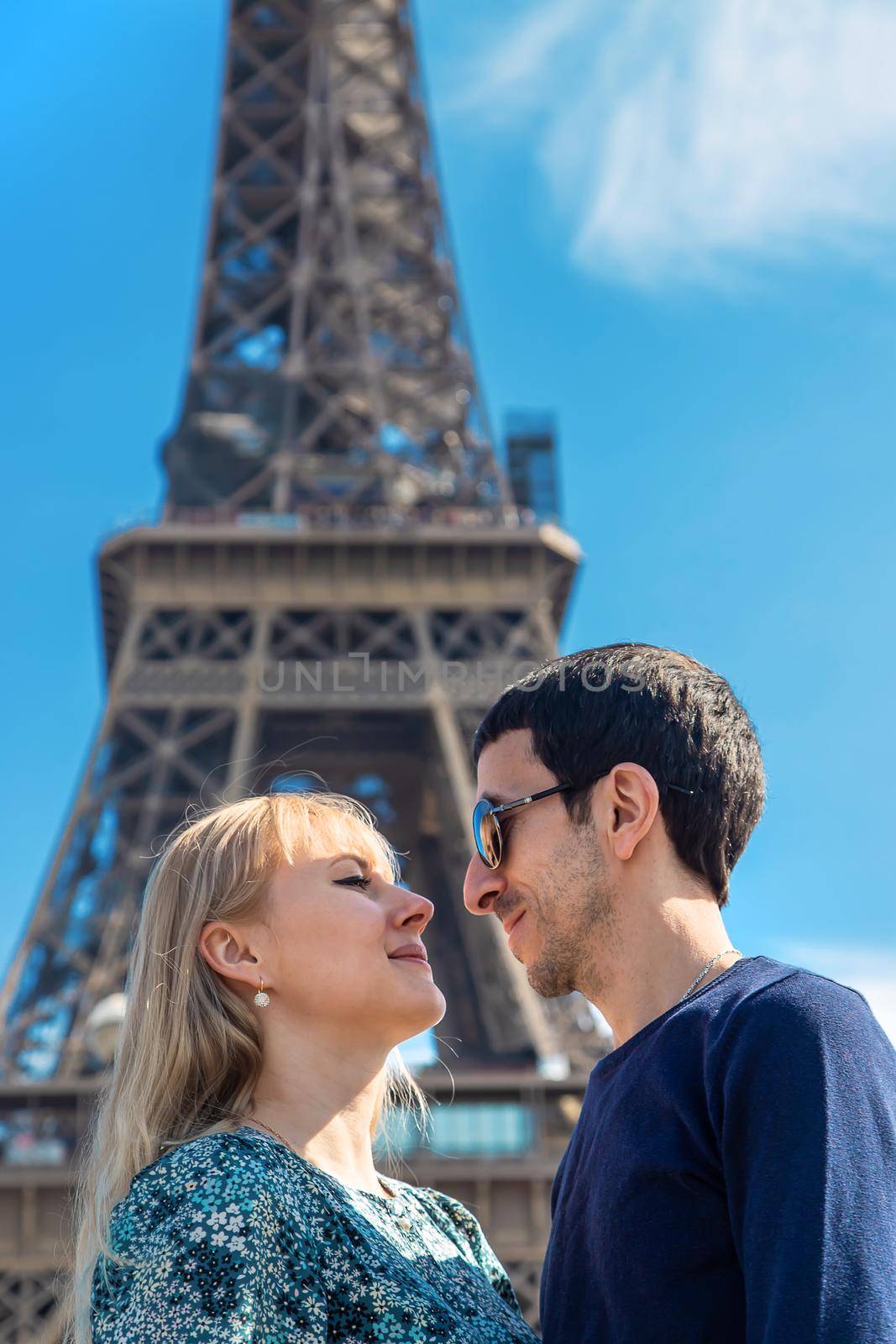 Couple woman and man near the eiffel tower. Selective focus. by yanadjana