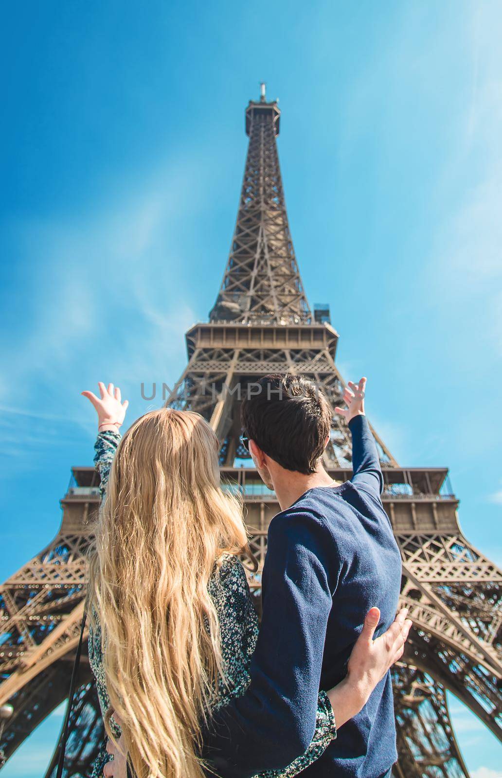 Couple woman and man near the eiffel tower. Selective focus. by yanadjana