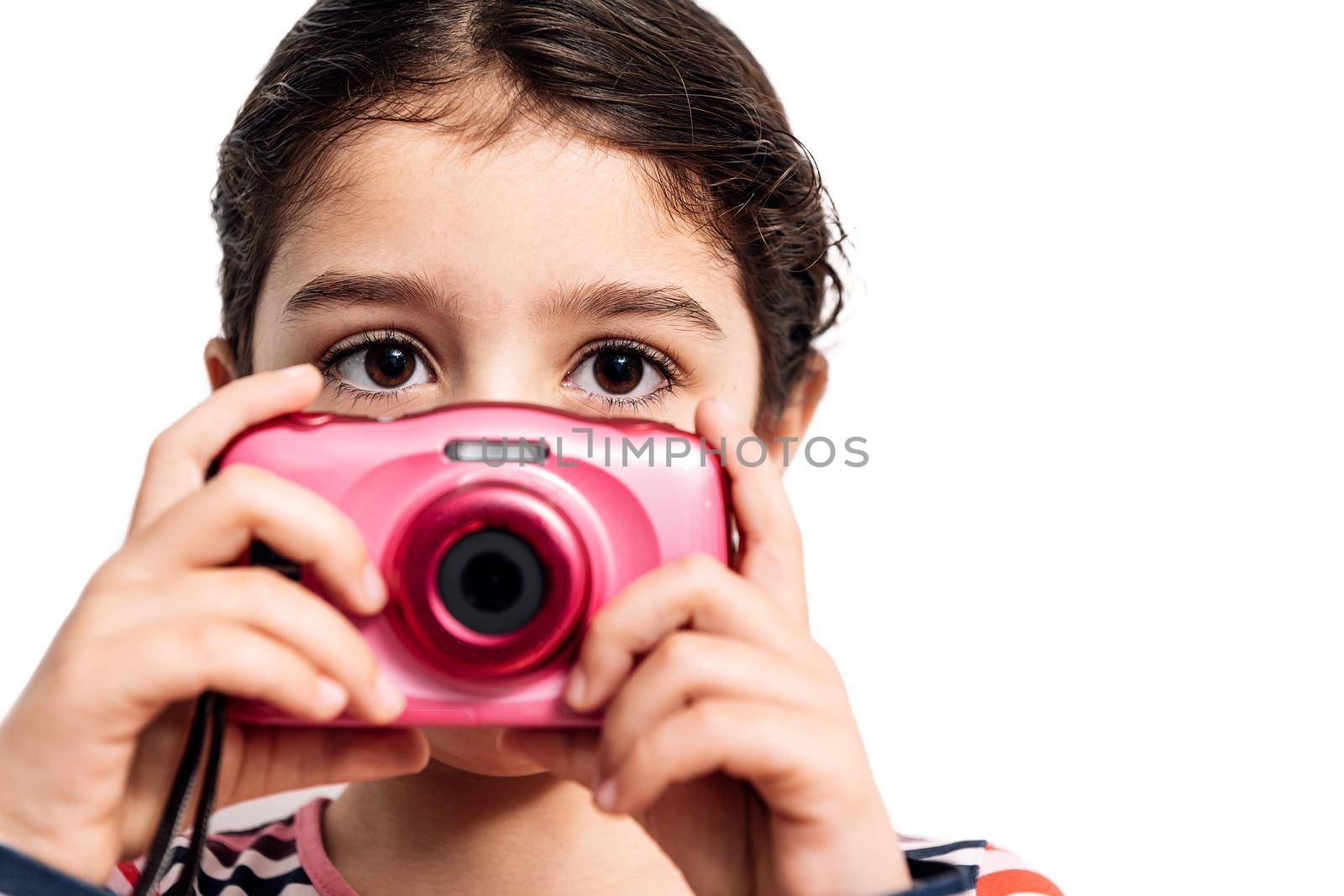 horizontal photo of a child looking at camera isolated on a white background taking photos, concept of kids and their hobbies, copy space for text