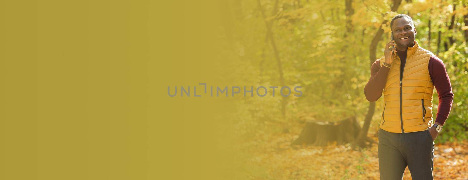 Banner african american student walking in the park in autumn season copy space by Satura86