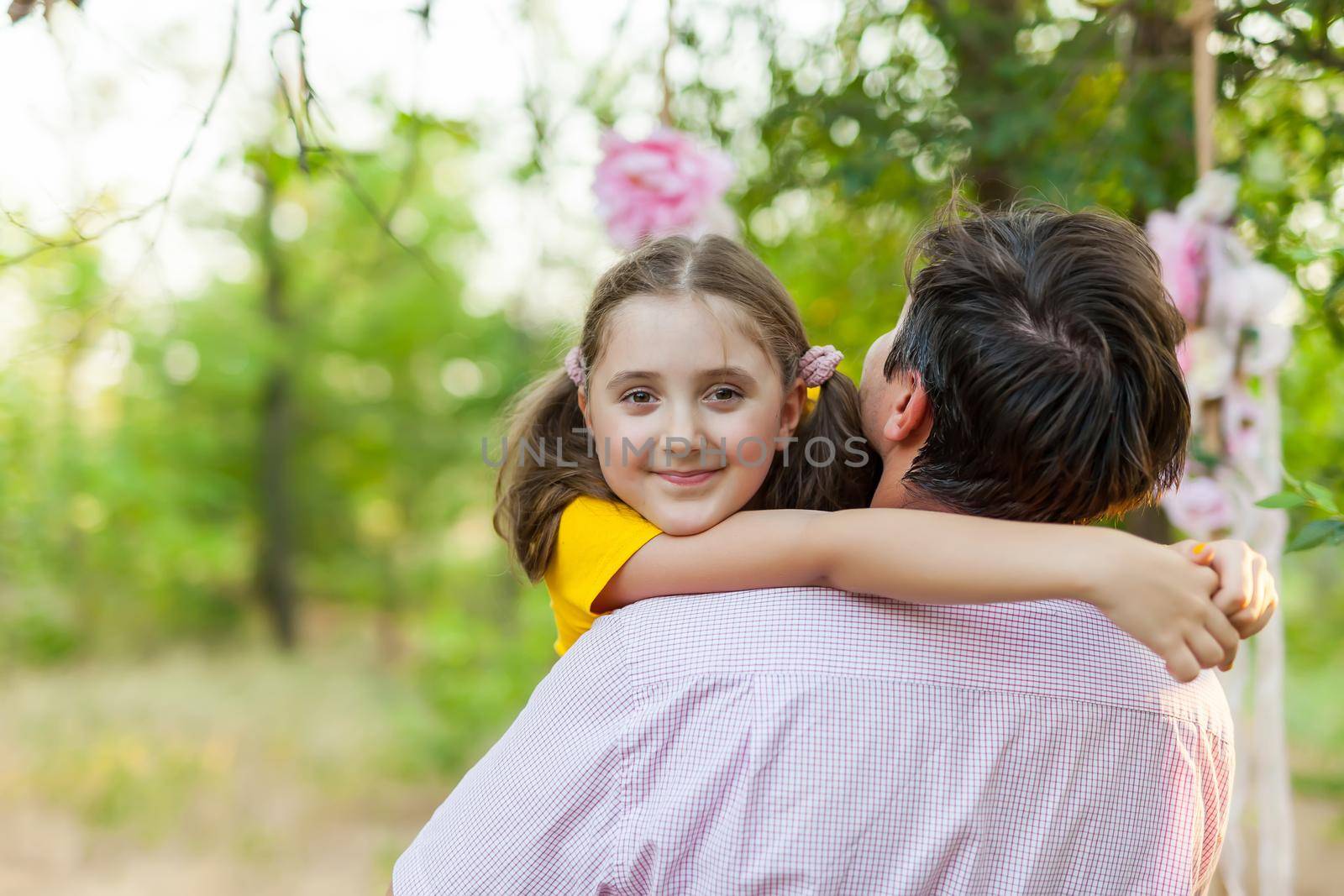 Smiling little girl hugging her father by InnaVlasova
