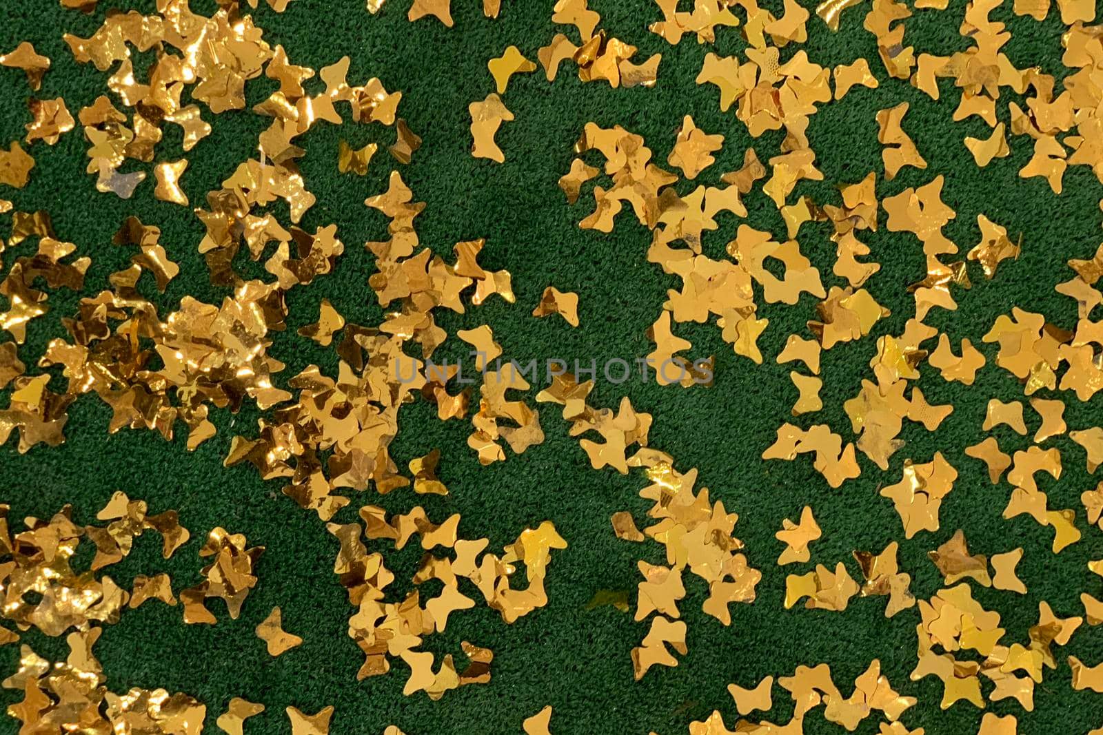 decorative shiny golden stars confetti on green background by Khosro1