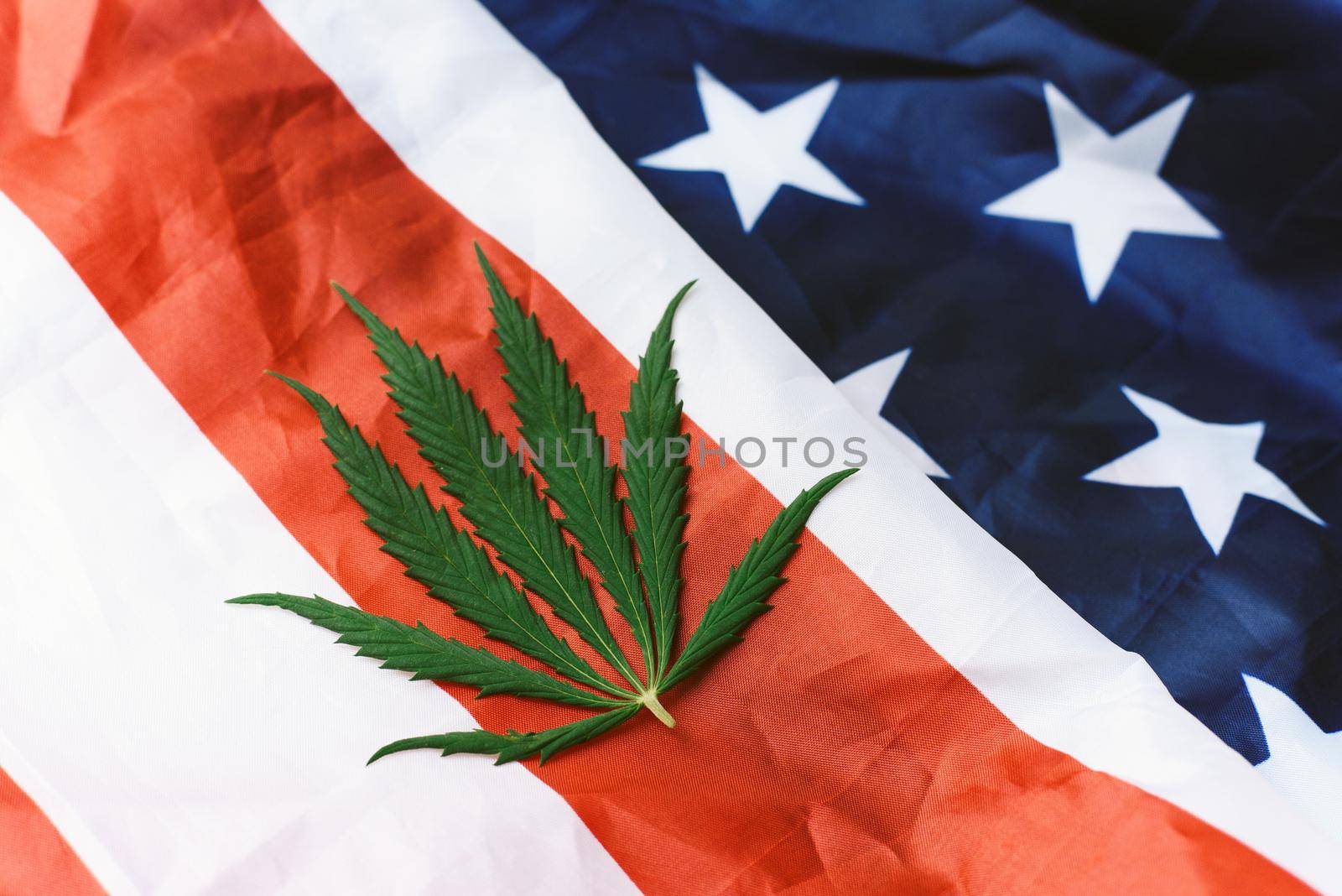 Cannabis or hemp leaf on the USA flag. View from above. Legalization of marijuana.