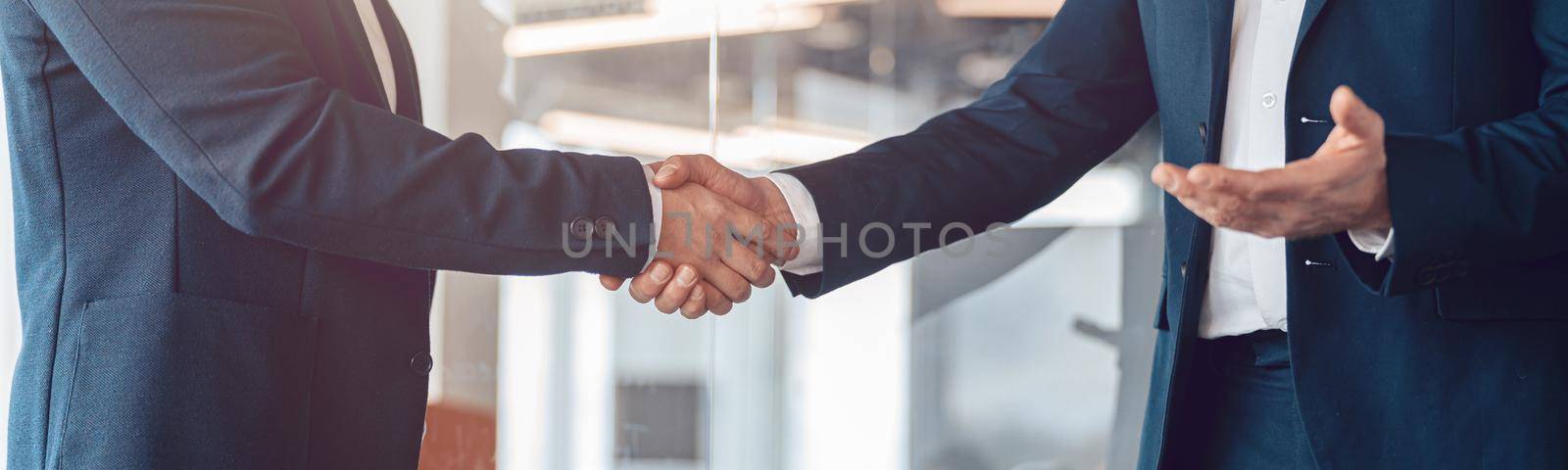 close up. handshake of business people before a business meeting in modern office by Yaroslav_astakhov