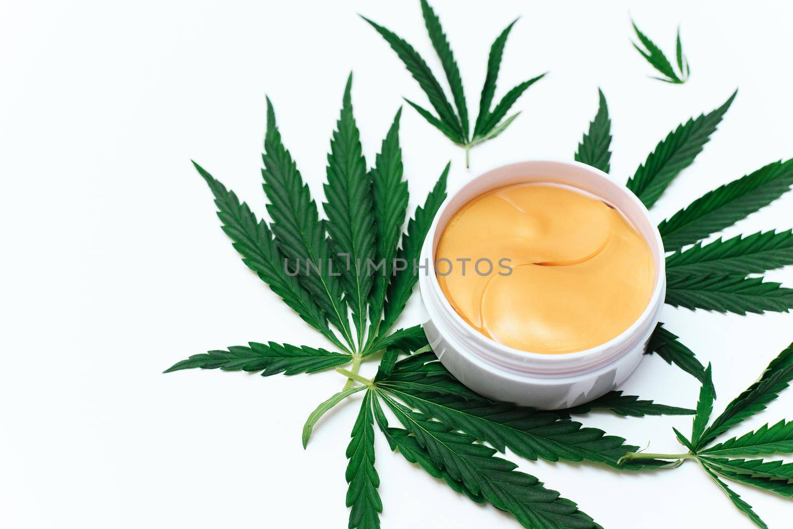 Hydrogel patches with cannabis or hemp oil on white background.