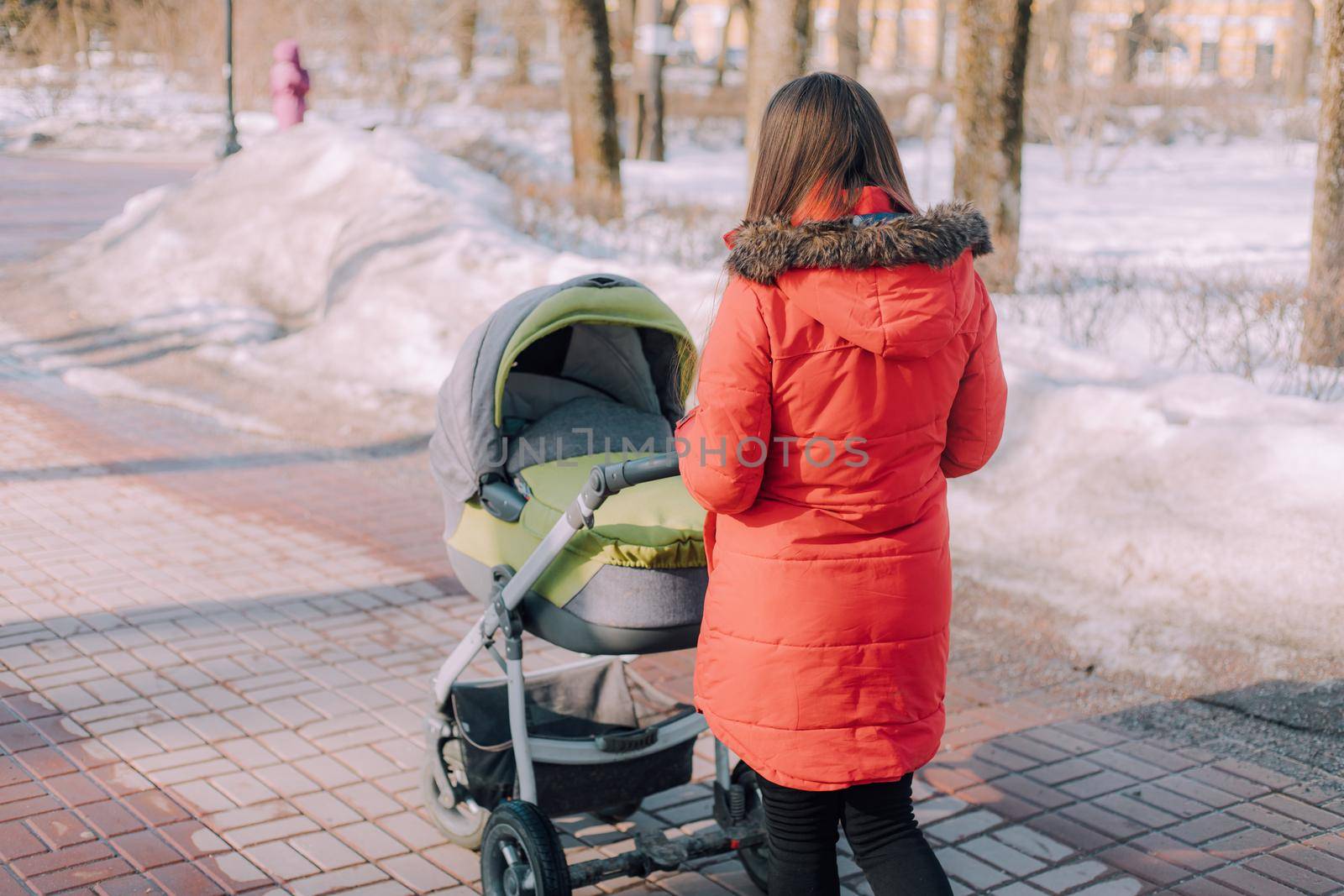 Mom on a walk with a stroller lifestyle. An article about choosing a stroller. An article about walking with children. The use of fresh air for kids. Modern moms. City walks with a stroller .