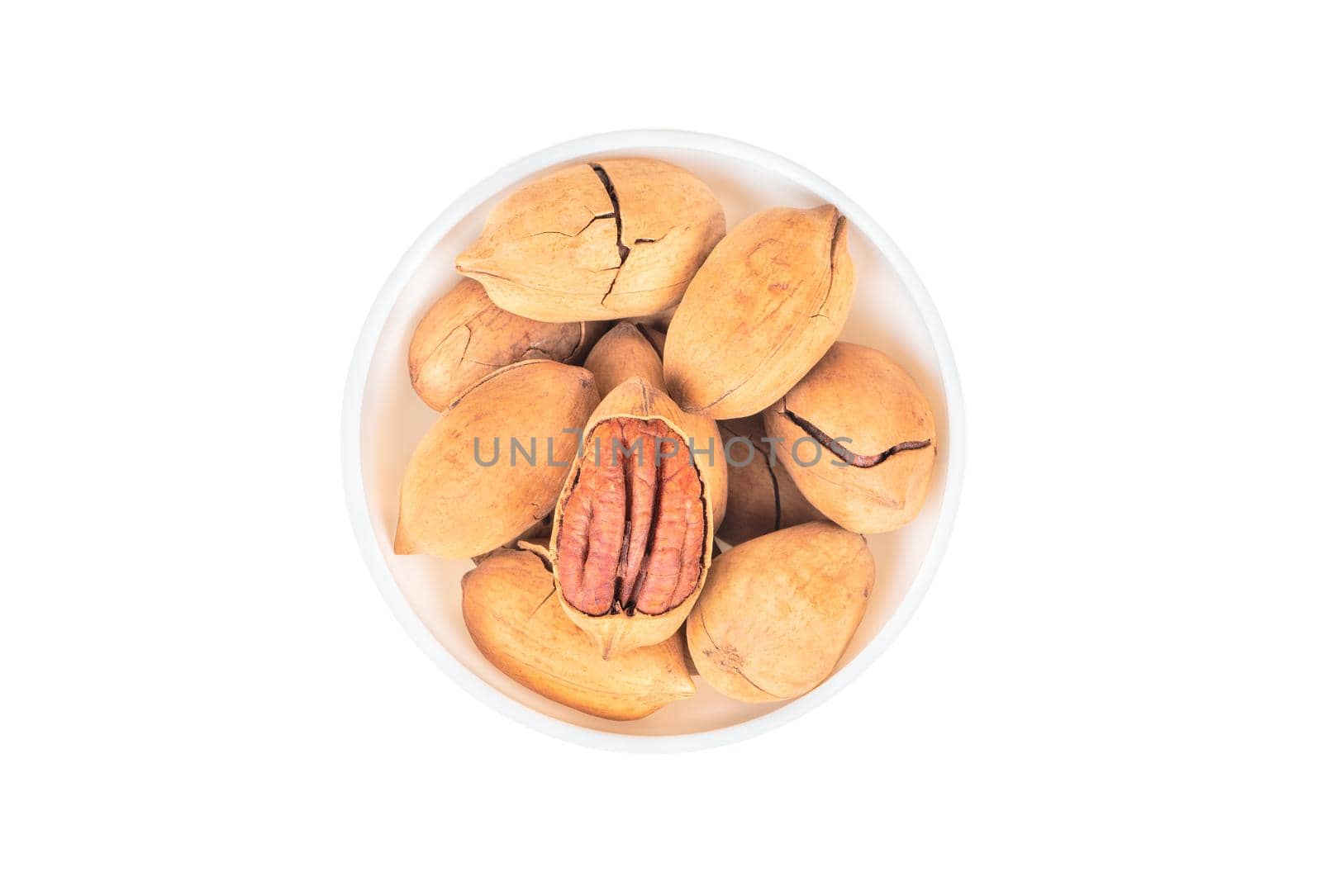 Pecan nuts in bowl on white background top view