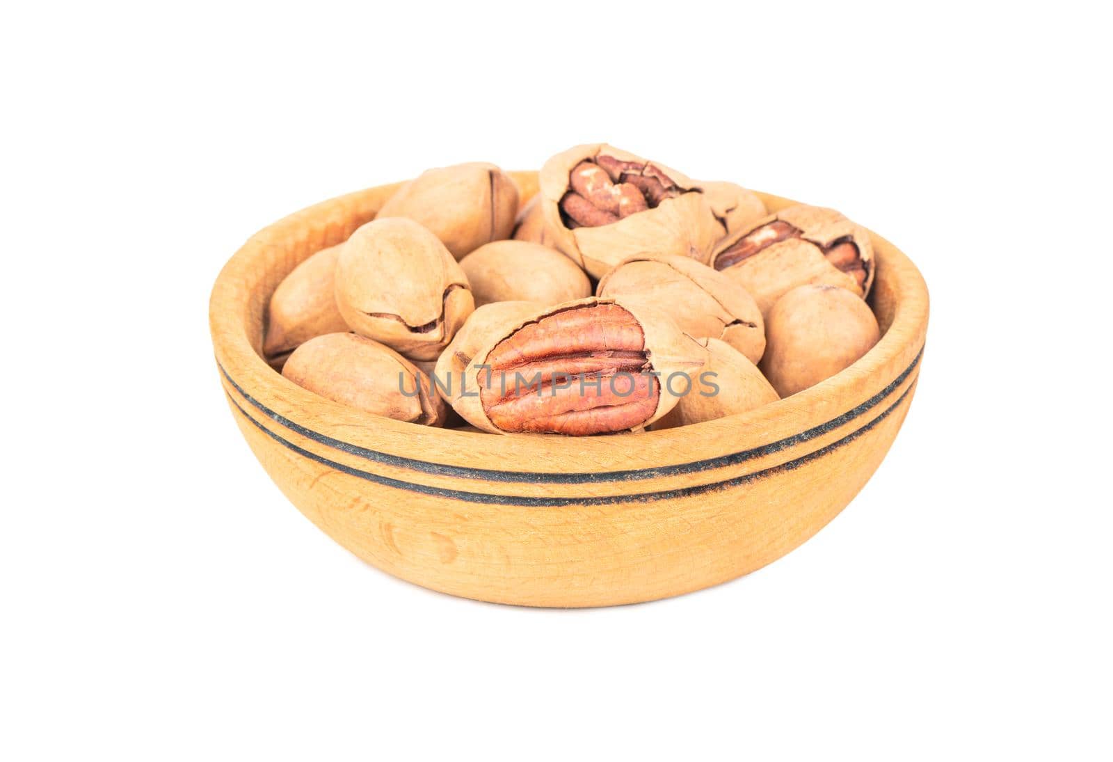 Pecan nuts in a large wooden bowl on a white background